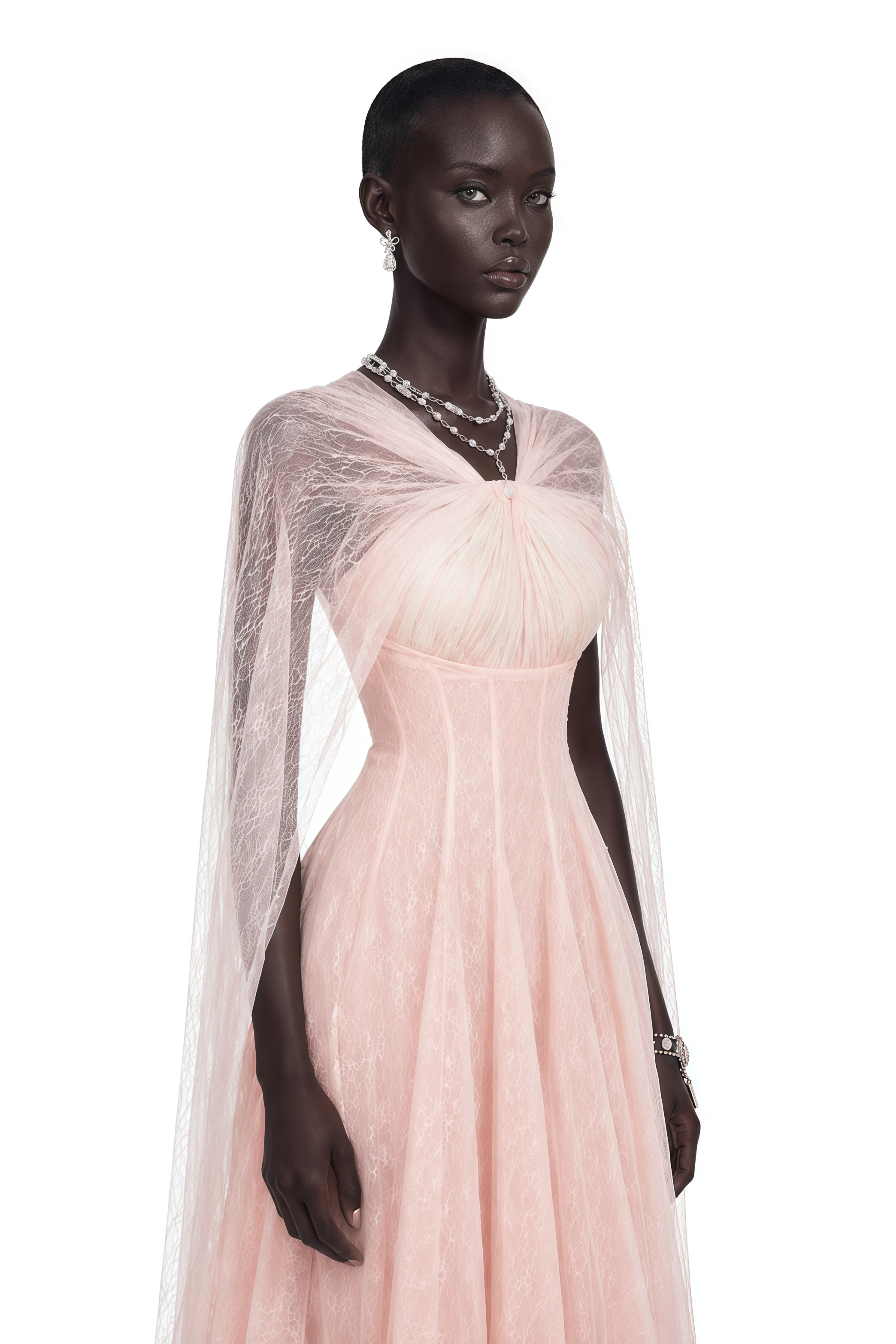 Light pink tulle gown with a corset bodice and matching sheer cape