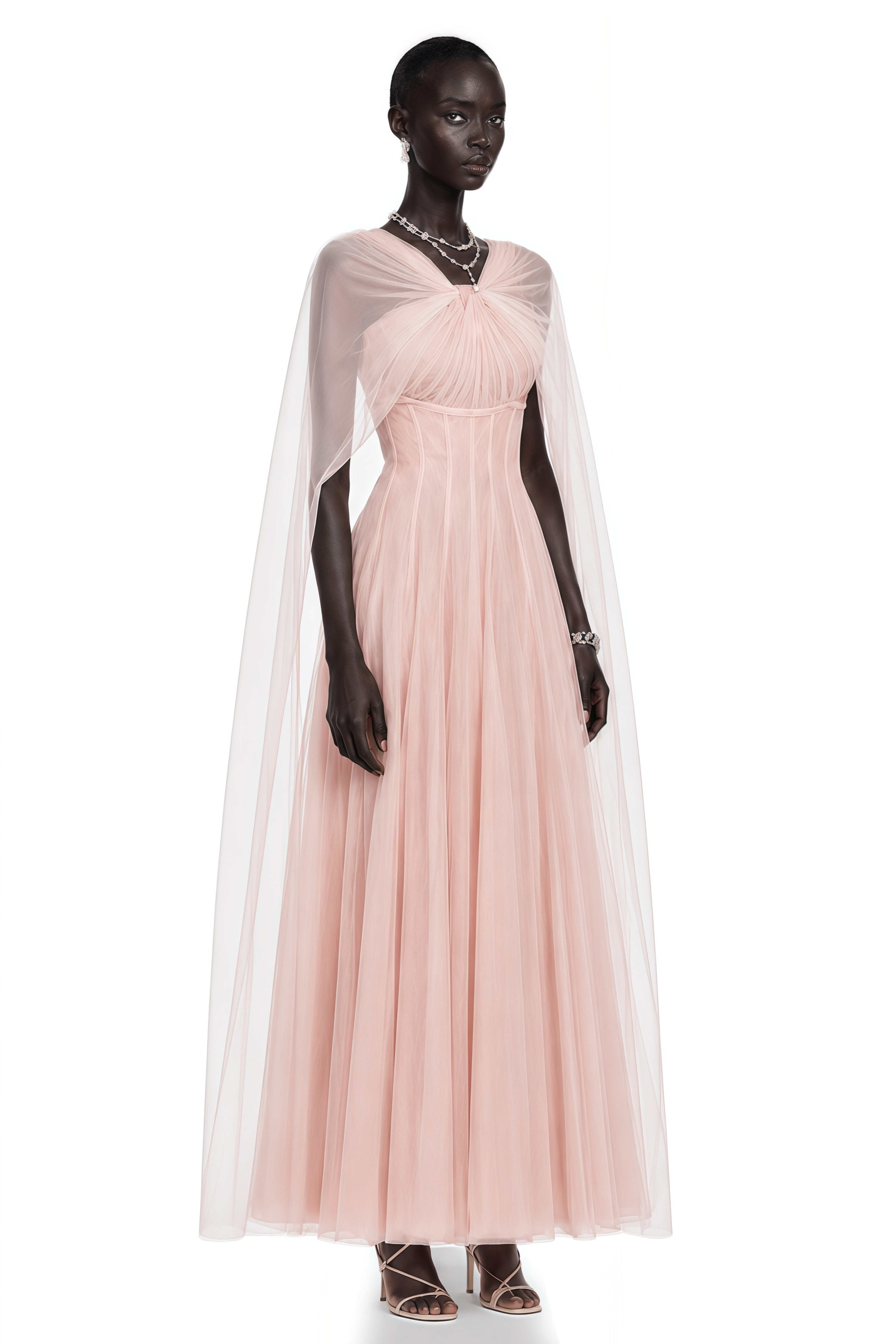 Light pink tulle gown with a corset bodice and matching sheer cape