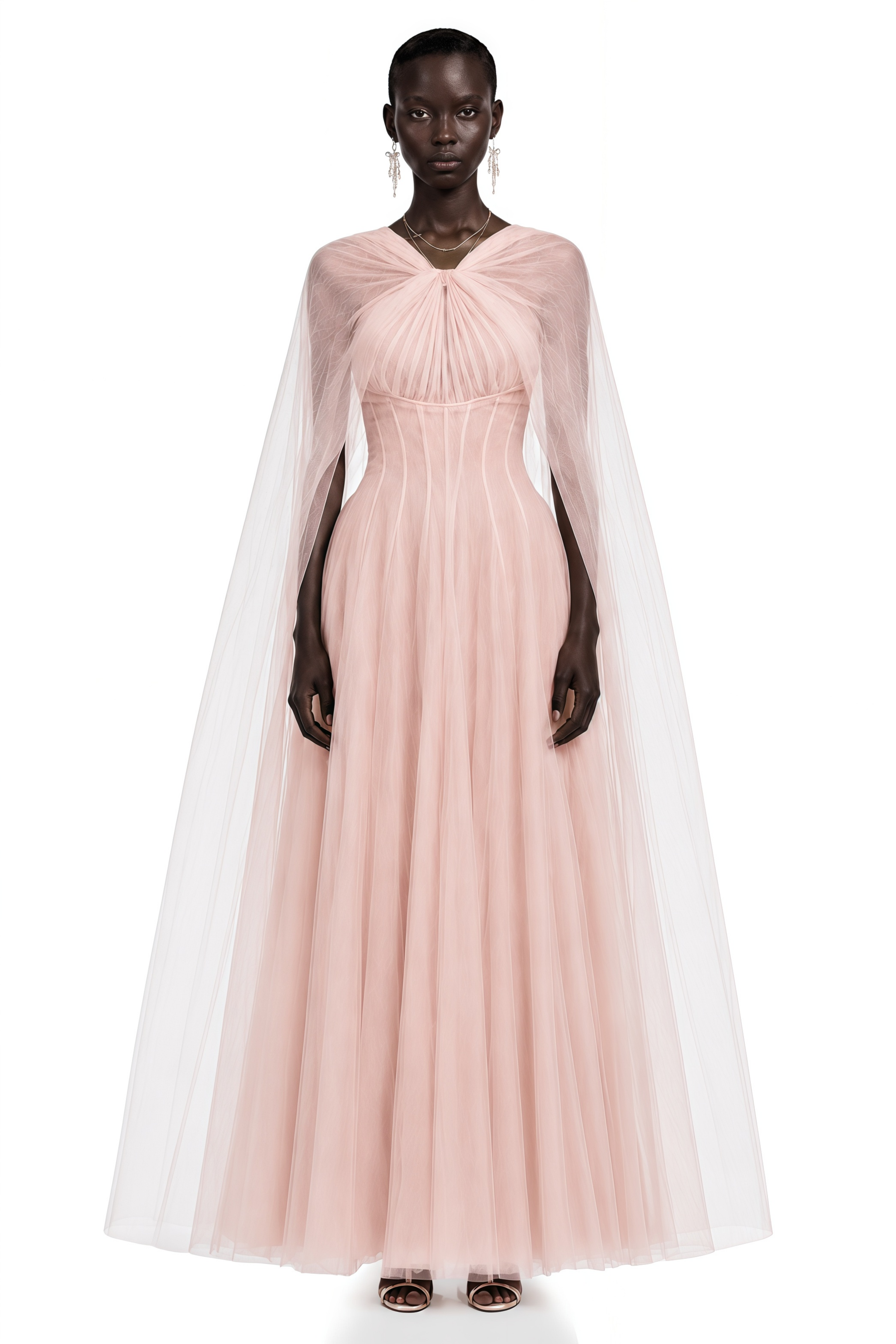Light pink tulle gown with a corset bodice and matching sheer cape