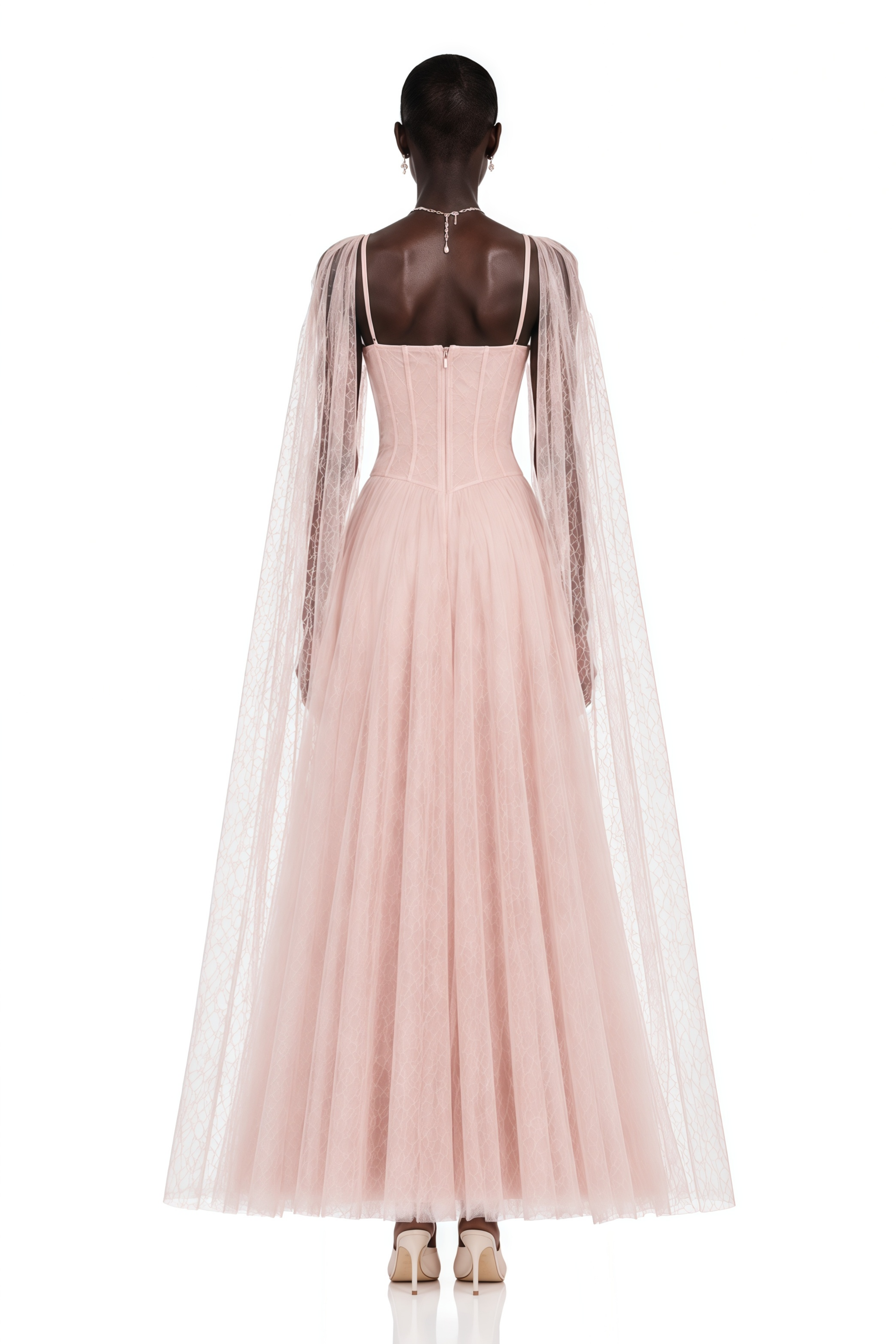 Light pink tulle gown with a corset bodice and matching sheer cape