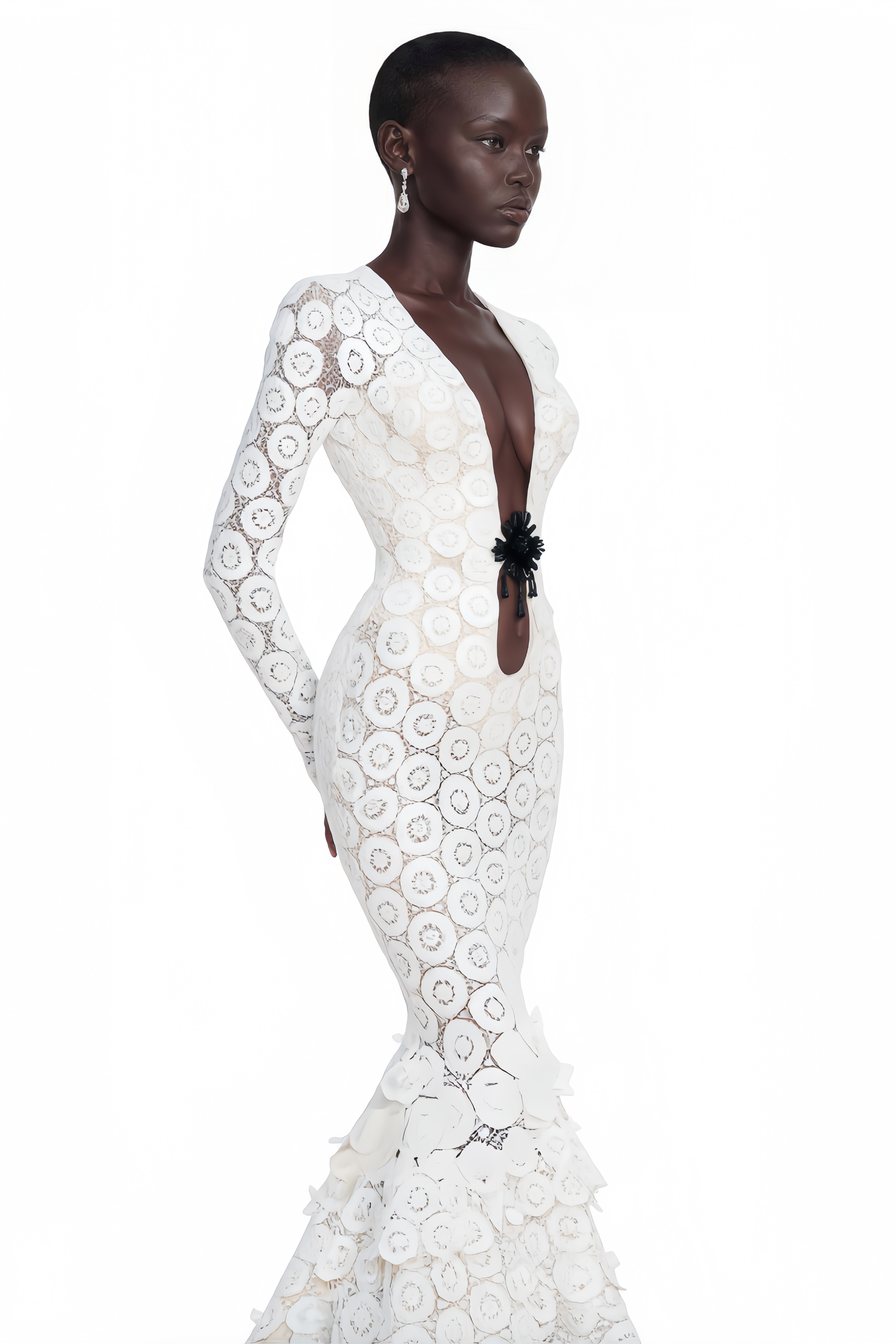 White lace maxi dress with a plunging neckline, cutout with floral detail, and a ruffled tiered train