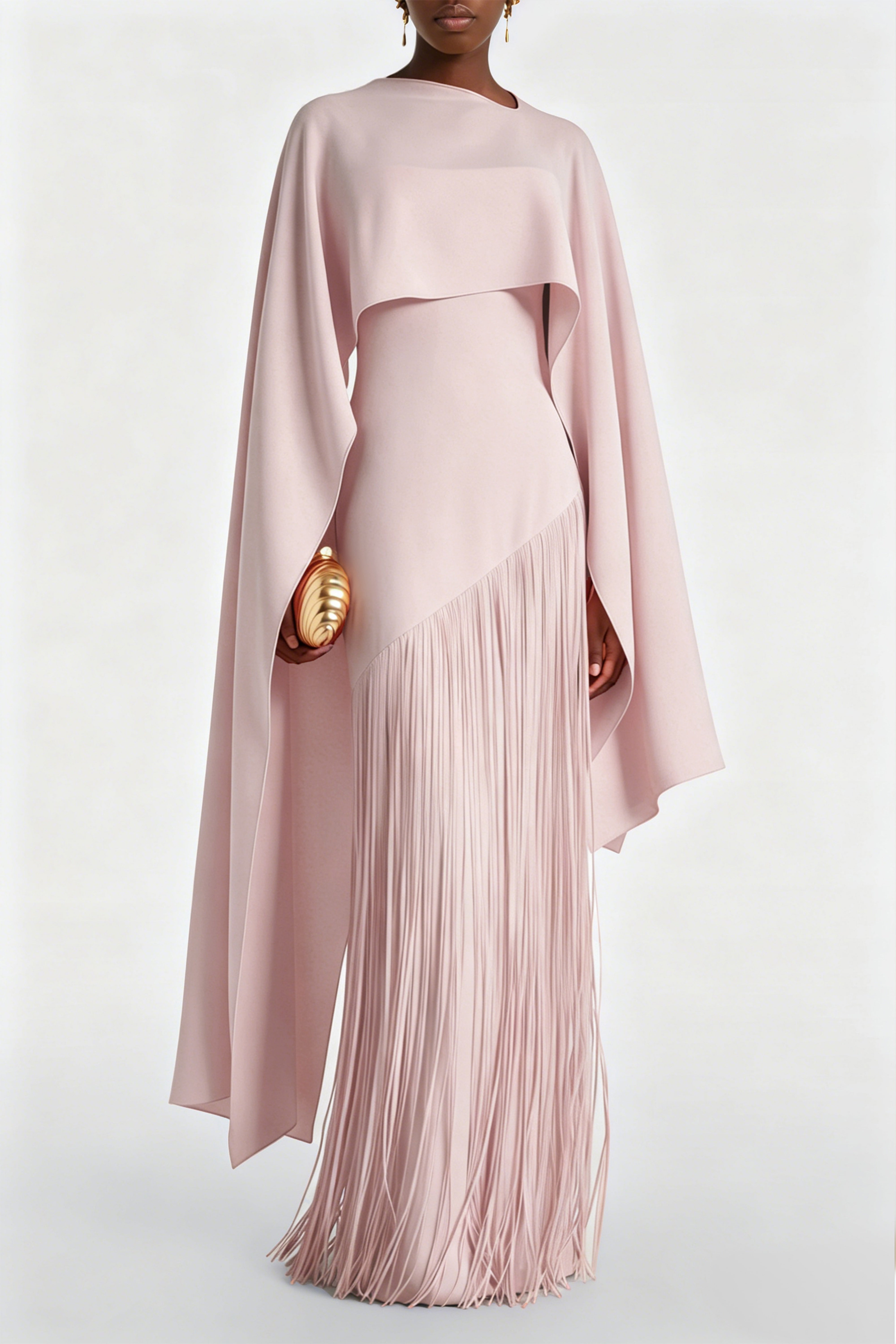 Blush pink maxi dress with a matching overlay cape and a long asymmetric fringe skirt