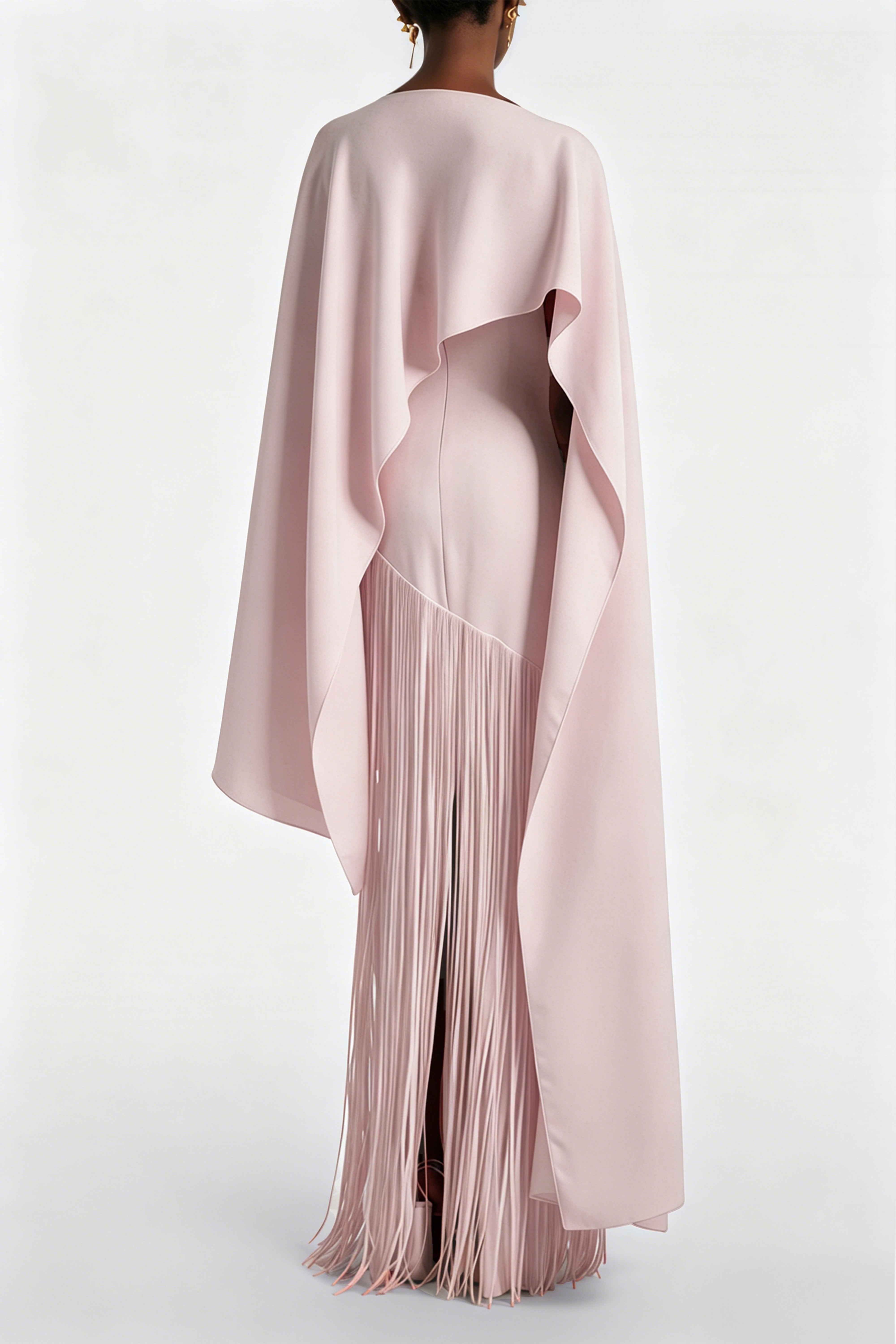 Blush pink maxi dress with a matching overlay cape and a long asymmetric fringe skirt