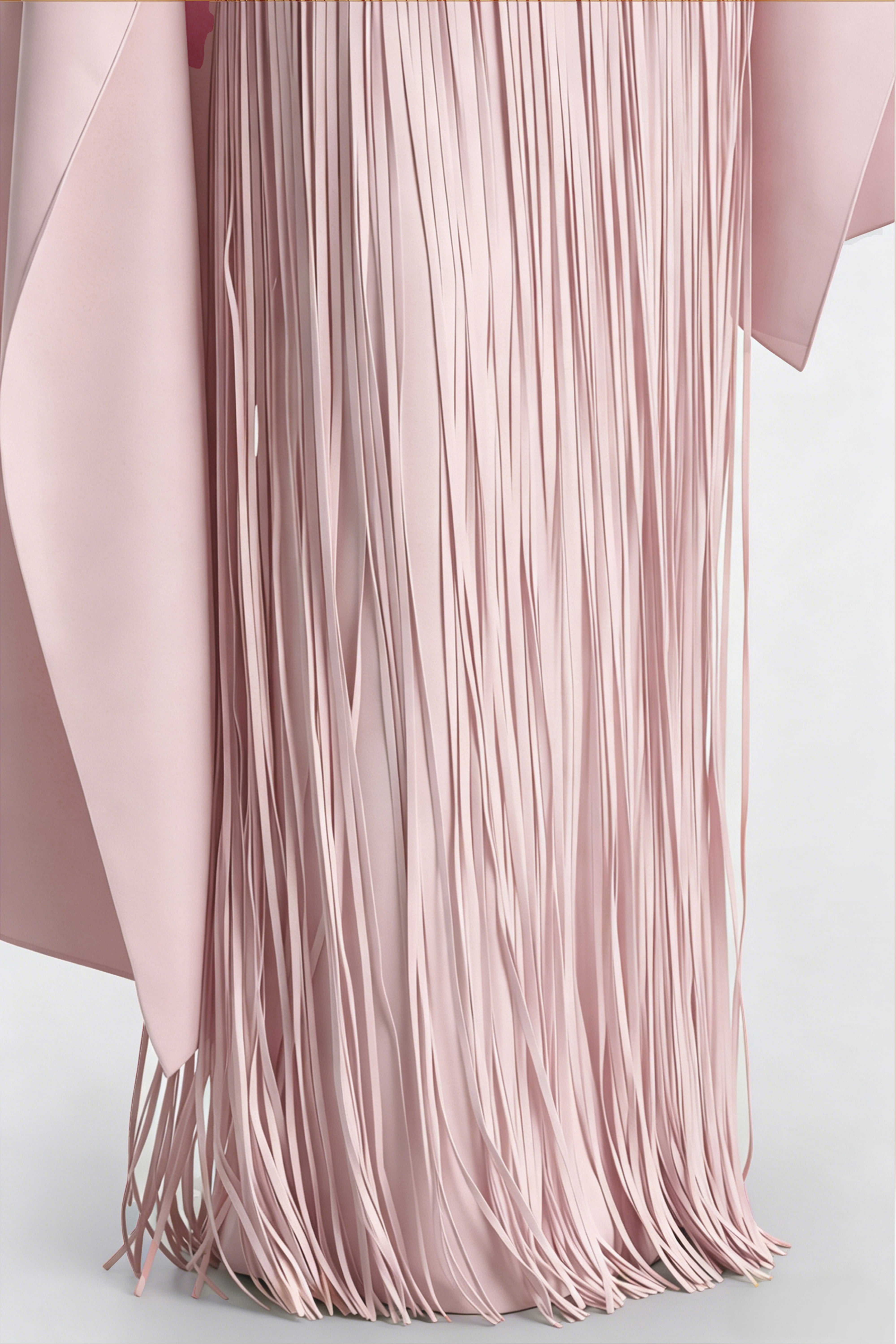 Blush pink maxi dress with a matching overlay cape and a long asymmetric fringe skirt