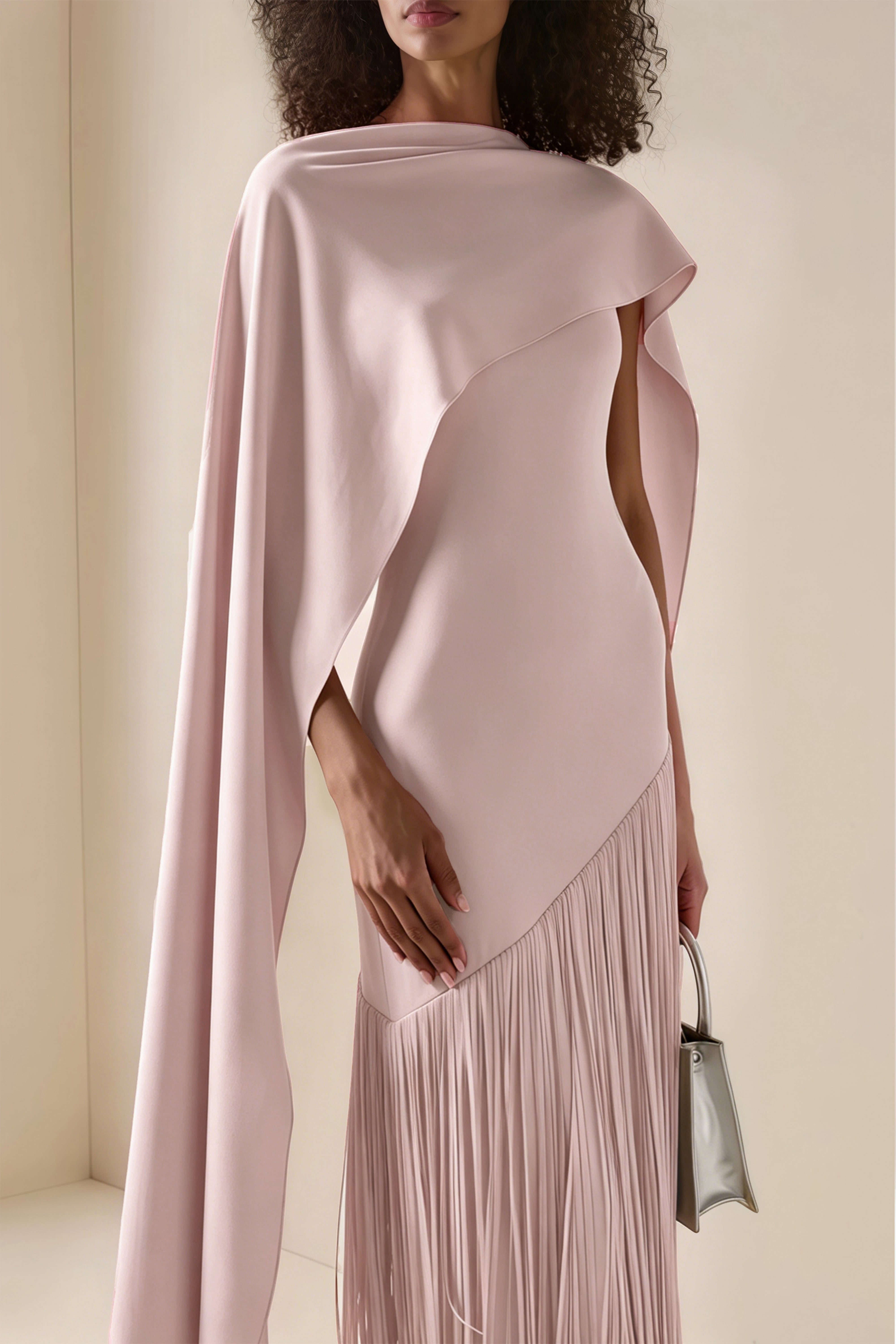 Blush pink maxi dress with a matching overlay cape and a long asymmetric fringe skirt