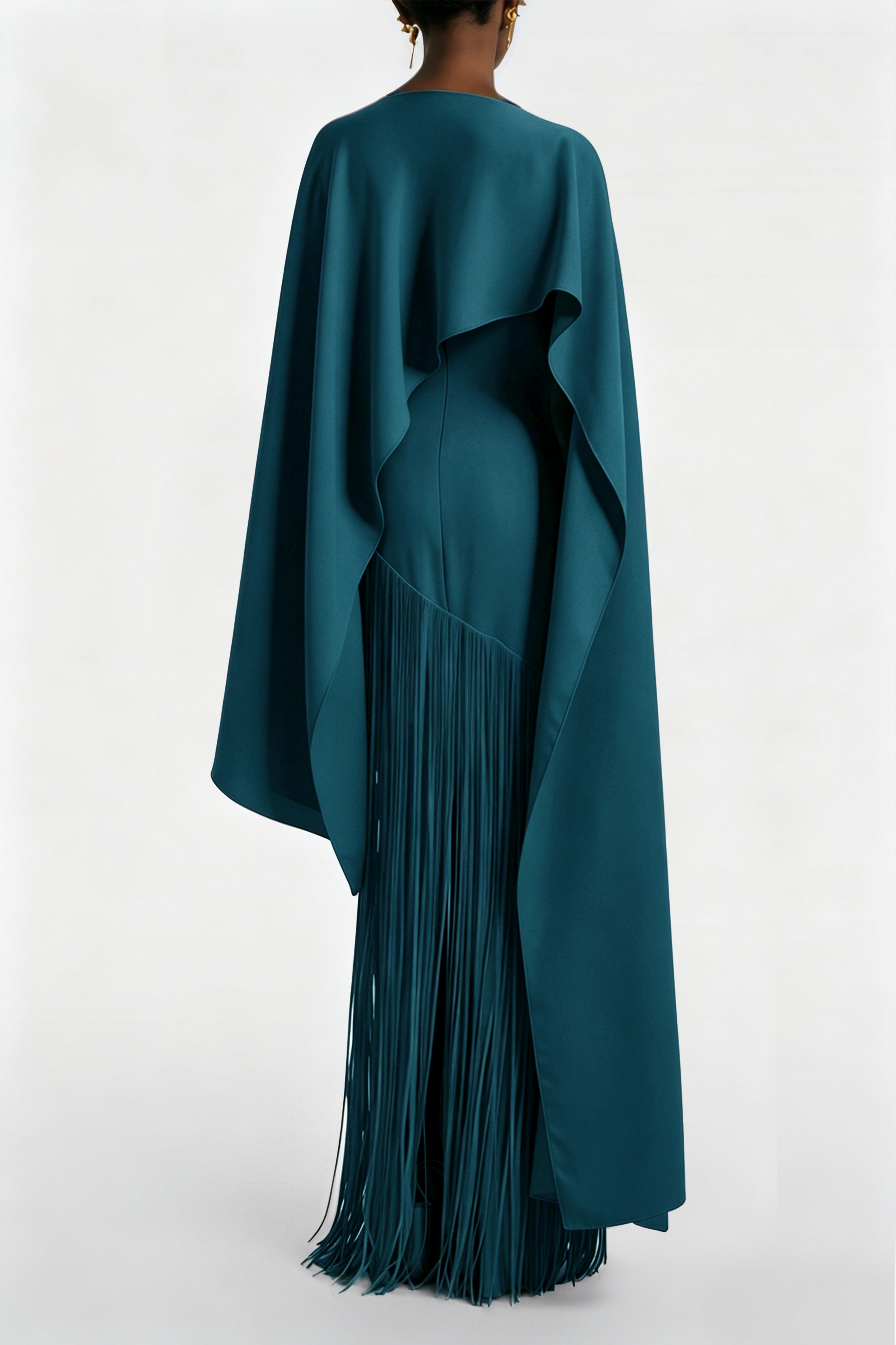 Teal blue maxi dress with a matching overlay cape and a long asymmetric fringe skirt