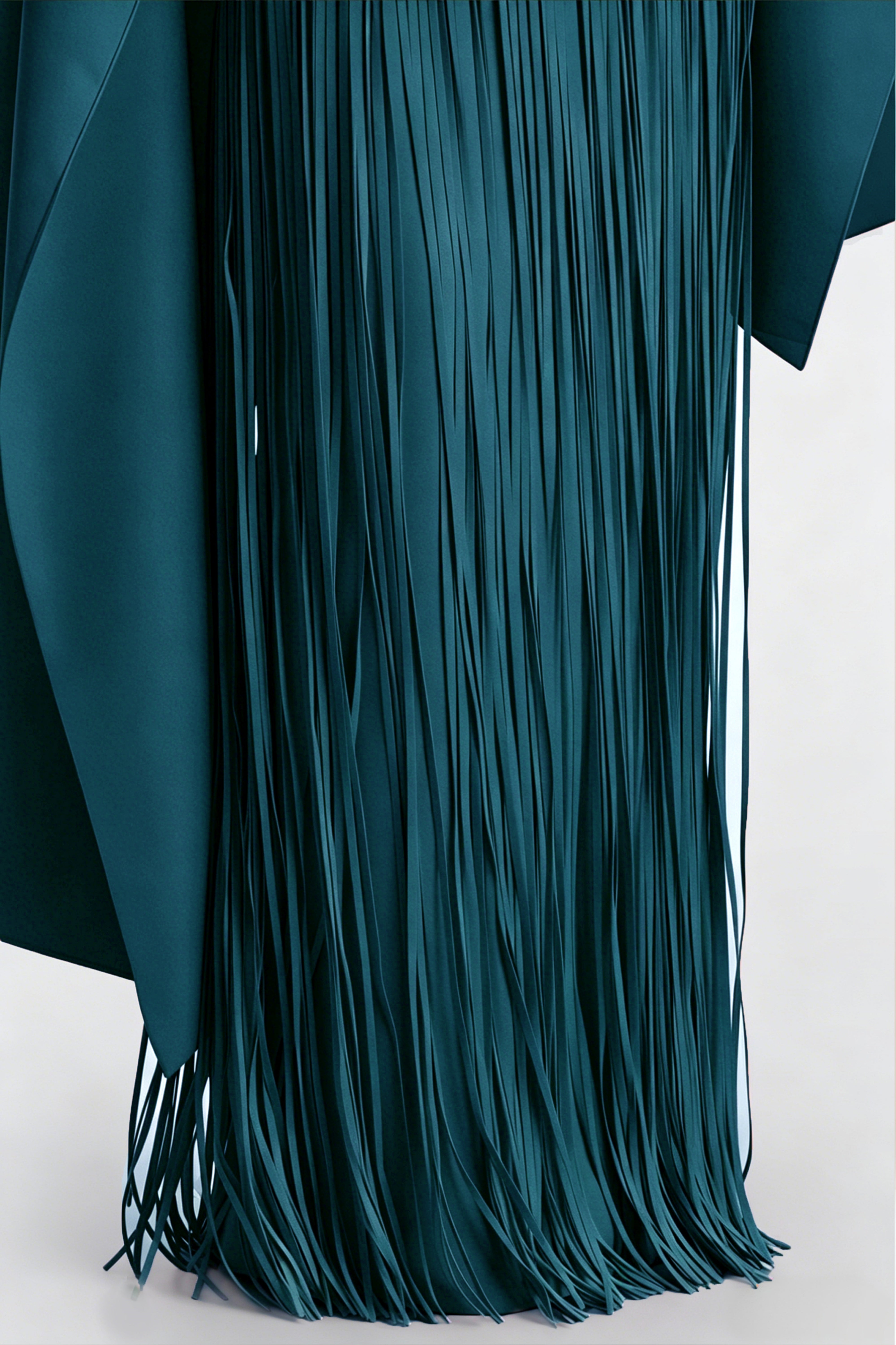 Teal blue maxi dress with a matching overlay cape and a long asymmetric fringe skirt
