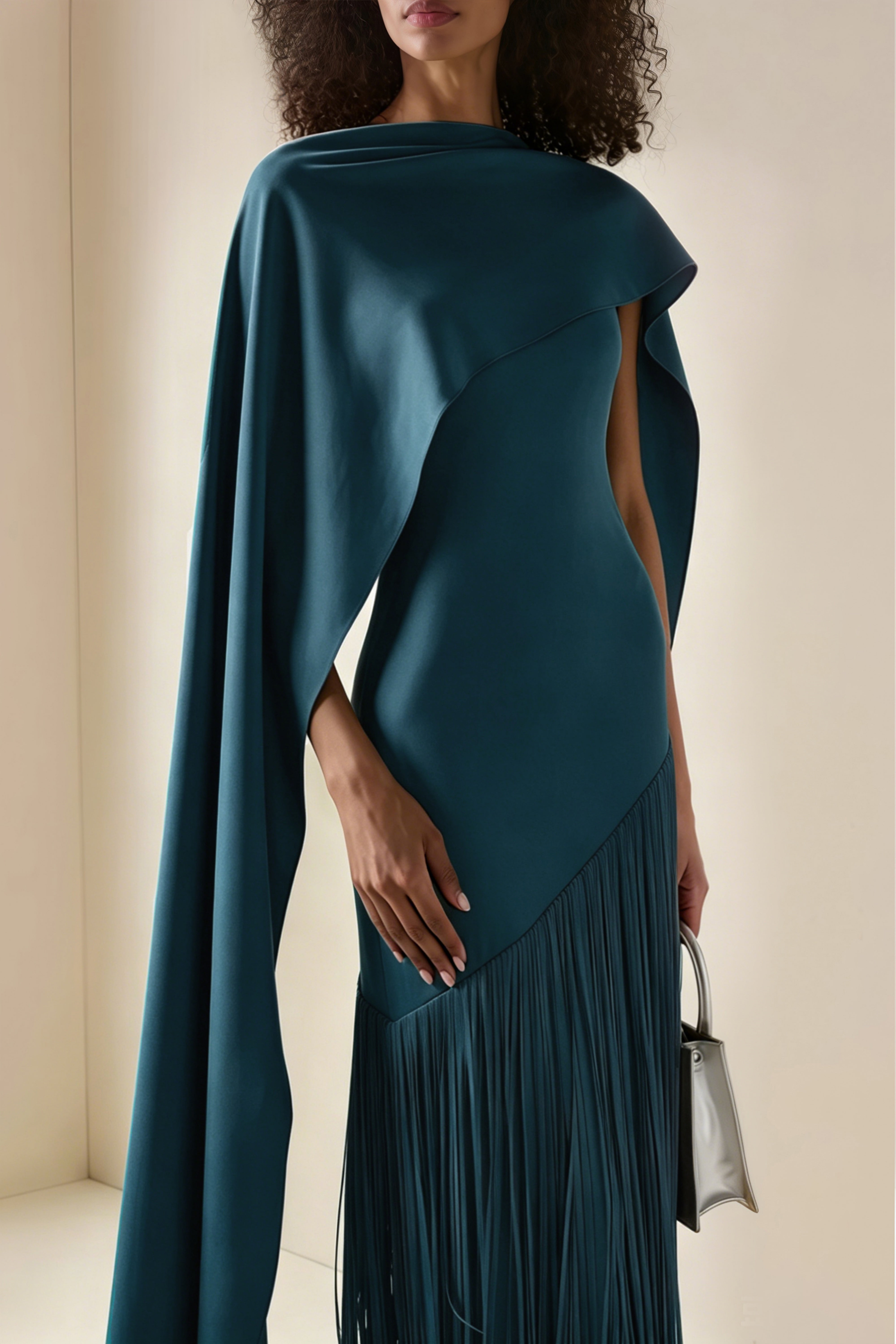Teal blue maxi dress with a matching overlay cape and a long asymmetric fringe skirt