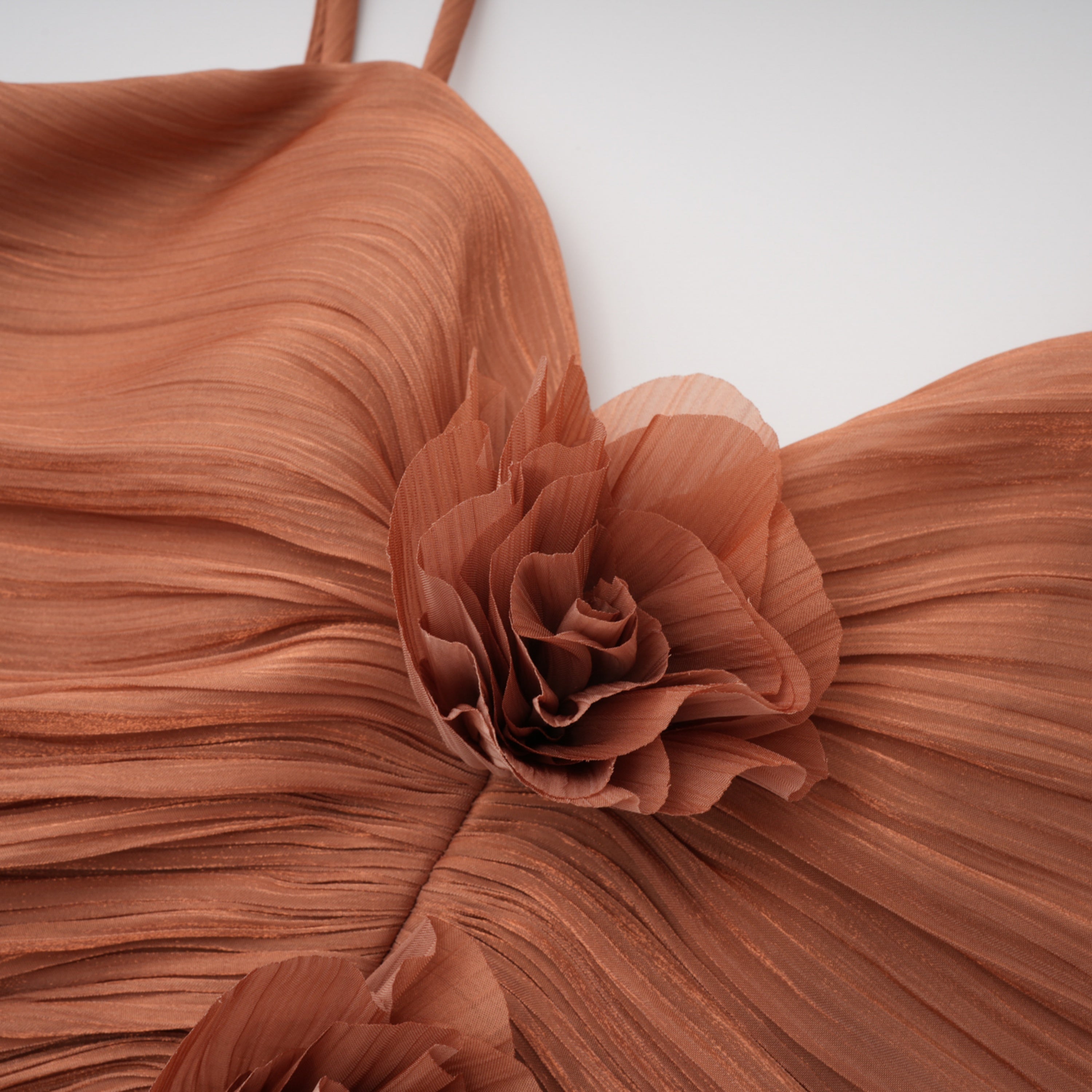 Terracotta gathered cape gown with floral rosettes