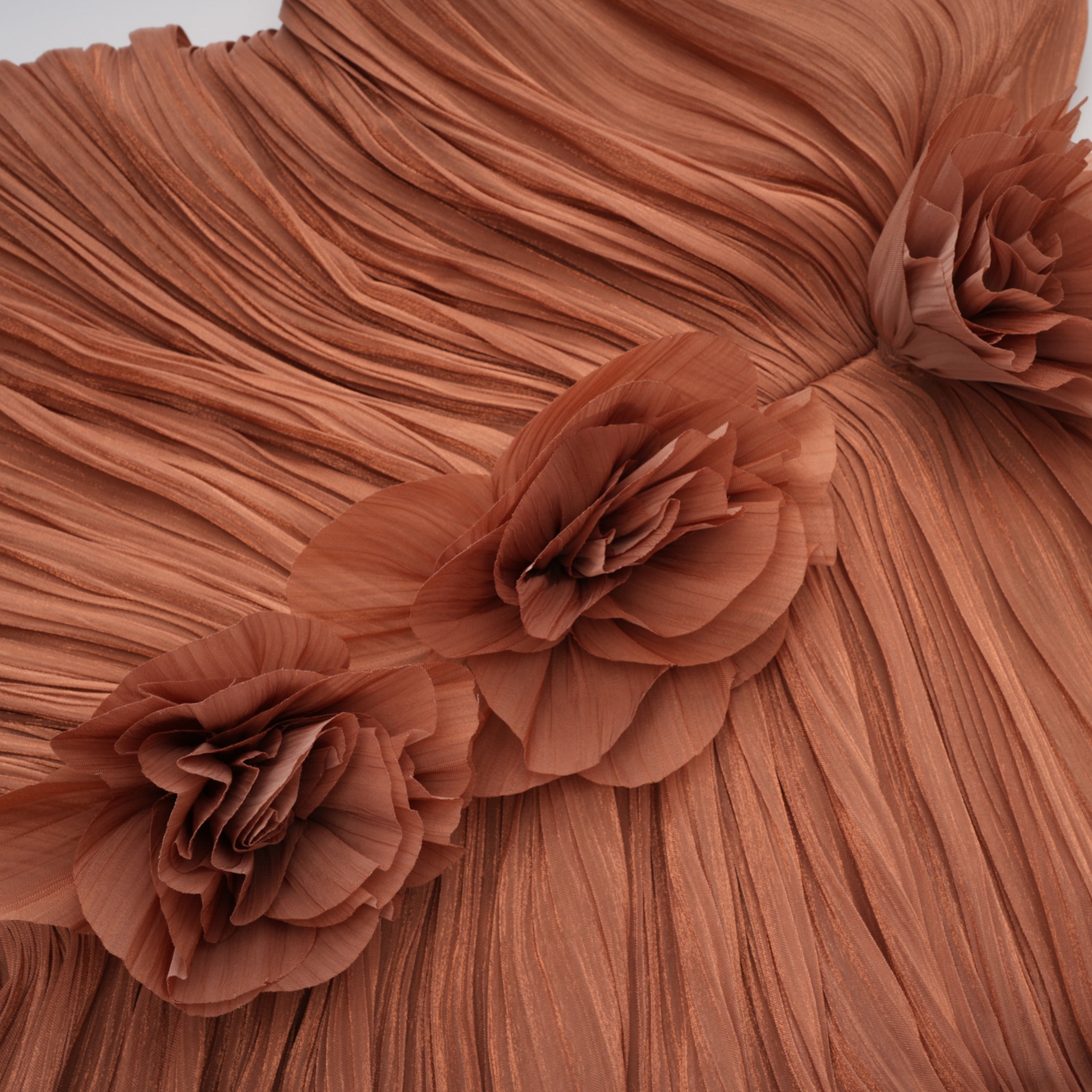 Terracotta gathered cape gown with floral rosettes