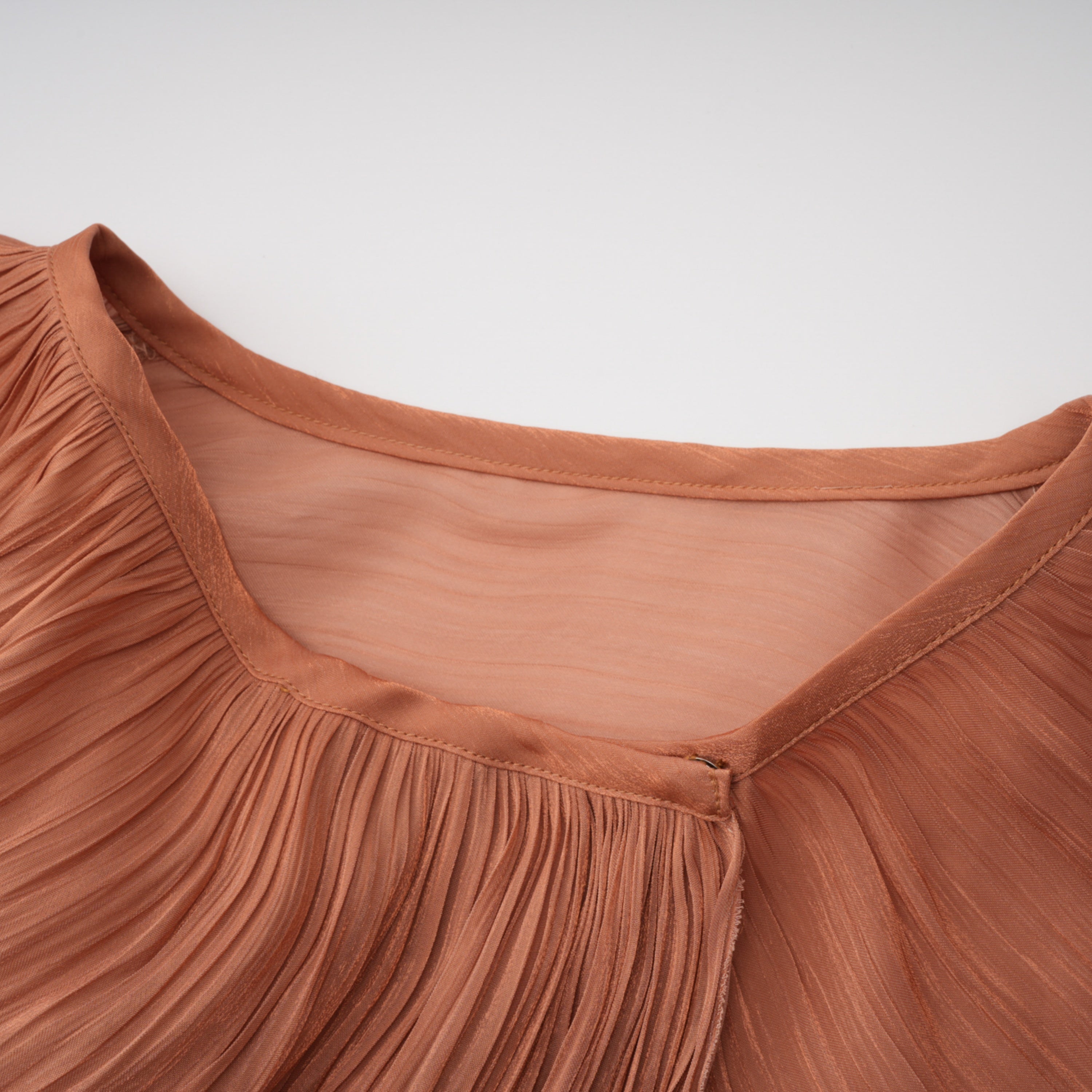 Terracotta gathered cape gown with floral rosettes
