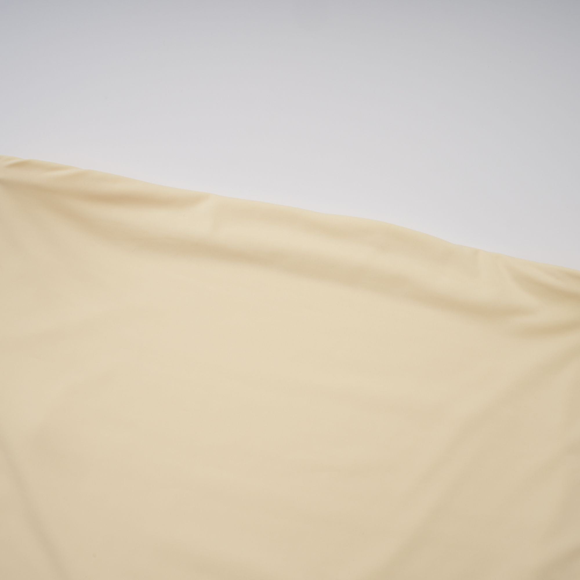 Pale yellow strapless gown with an asymmetrical bodice and pleated sheer skirt