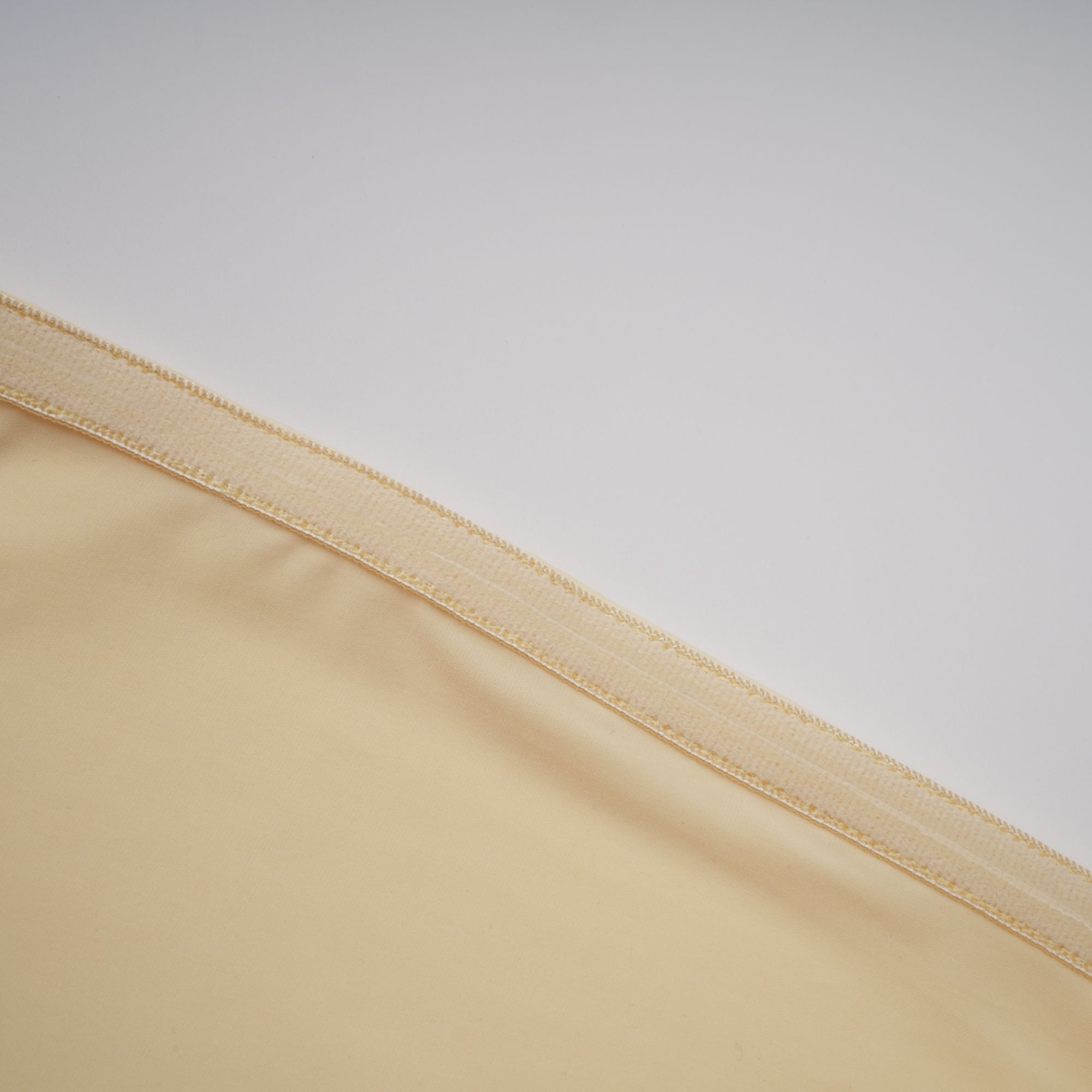 Pale yellow strapless gown with an asymmetrical bodice and pleated sheer skirt