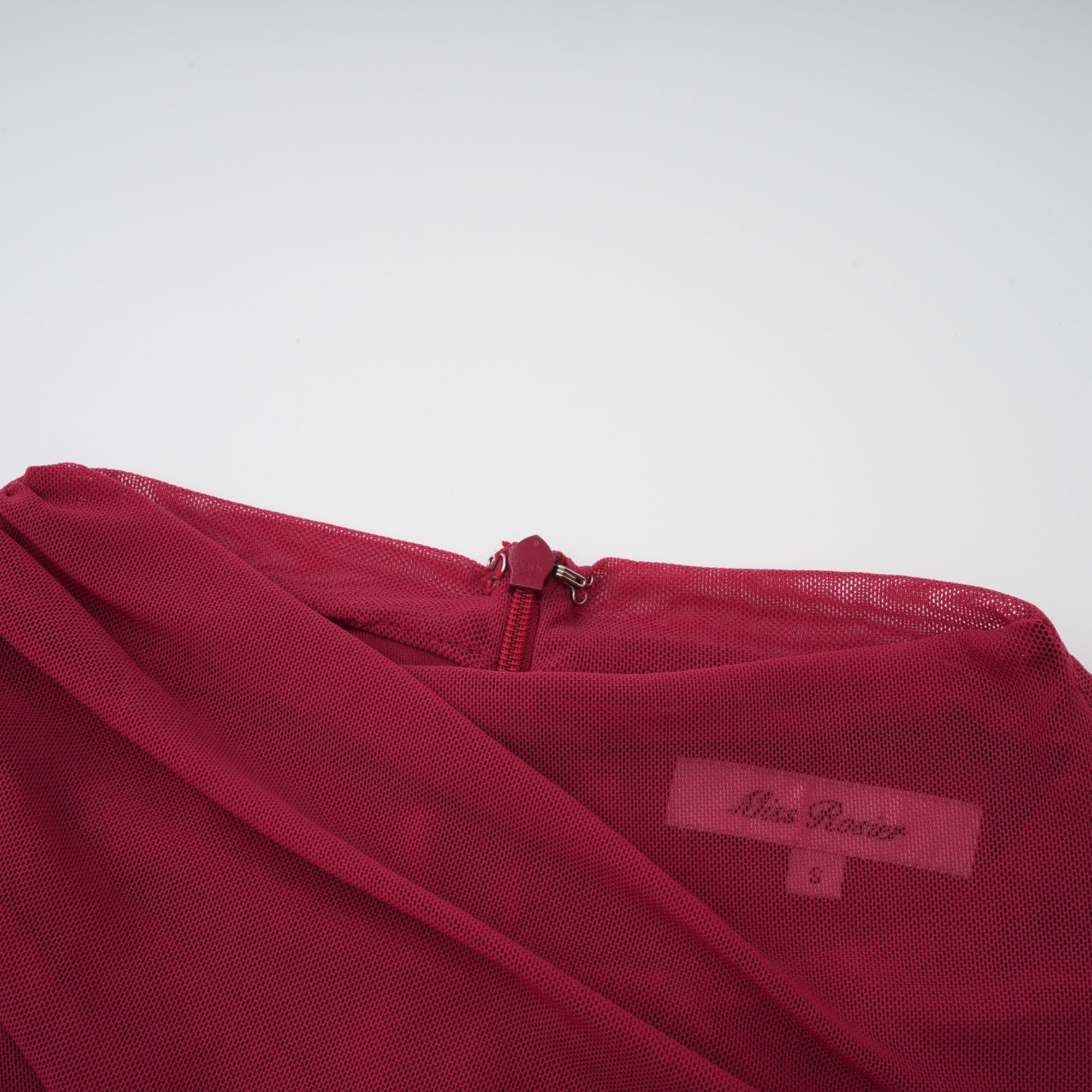 Burgundy ruched gown with a draped high neckline and sheer skirt