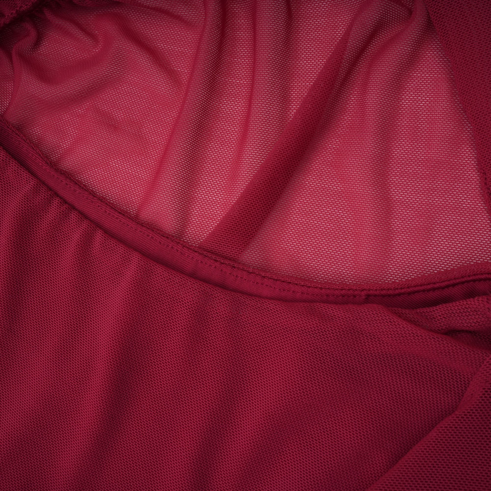 Burgundy ruched gown with a draped high neckline and sheer skirt