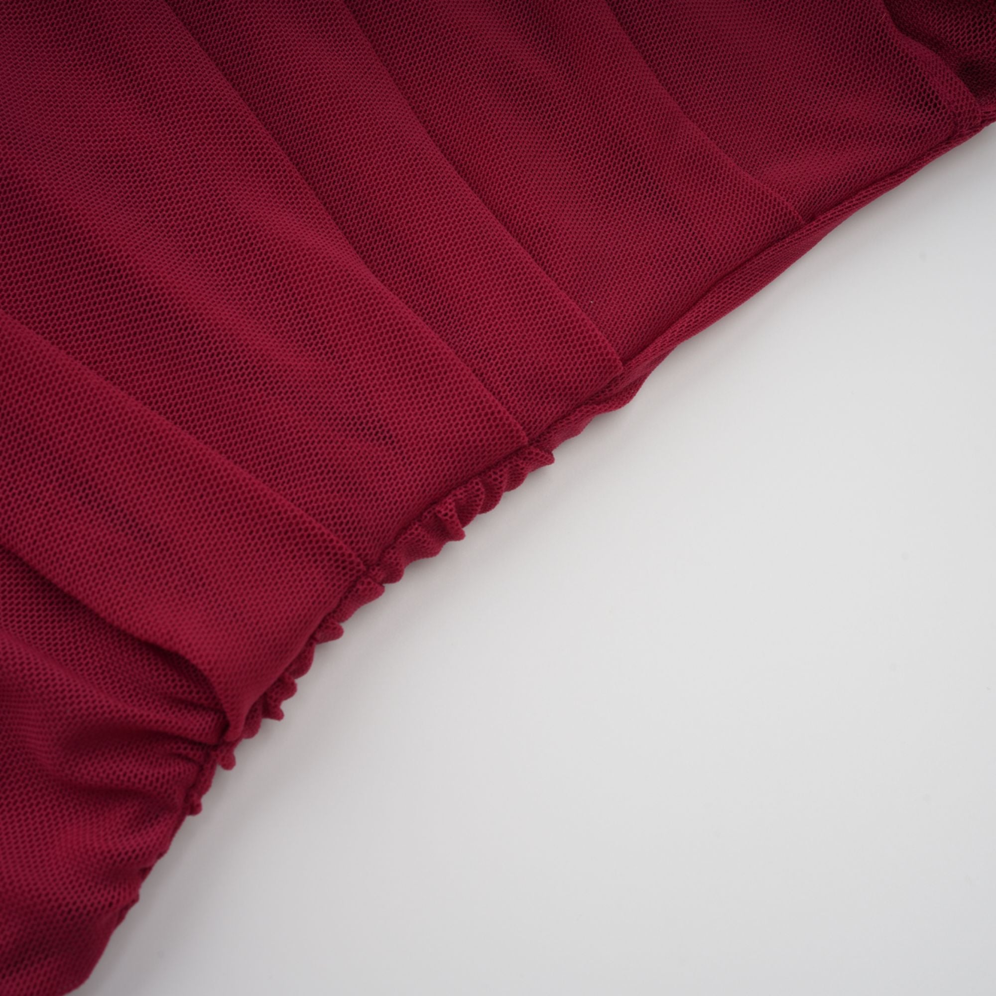 Burgundy ruched gown with a draped high neckline and sheer skirt