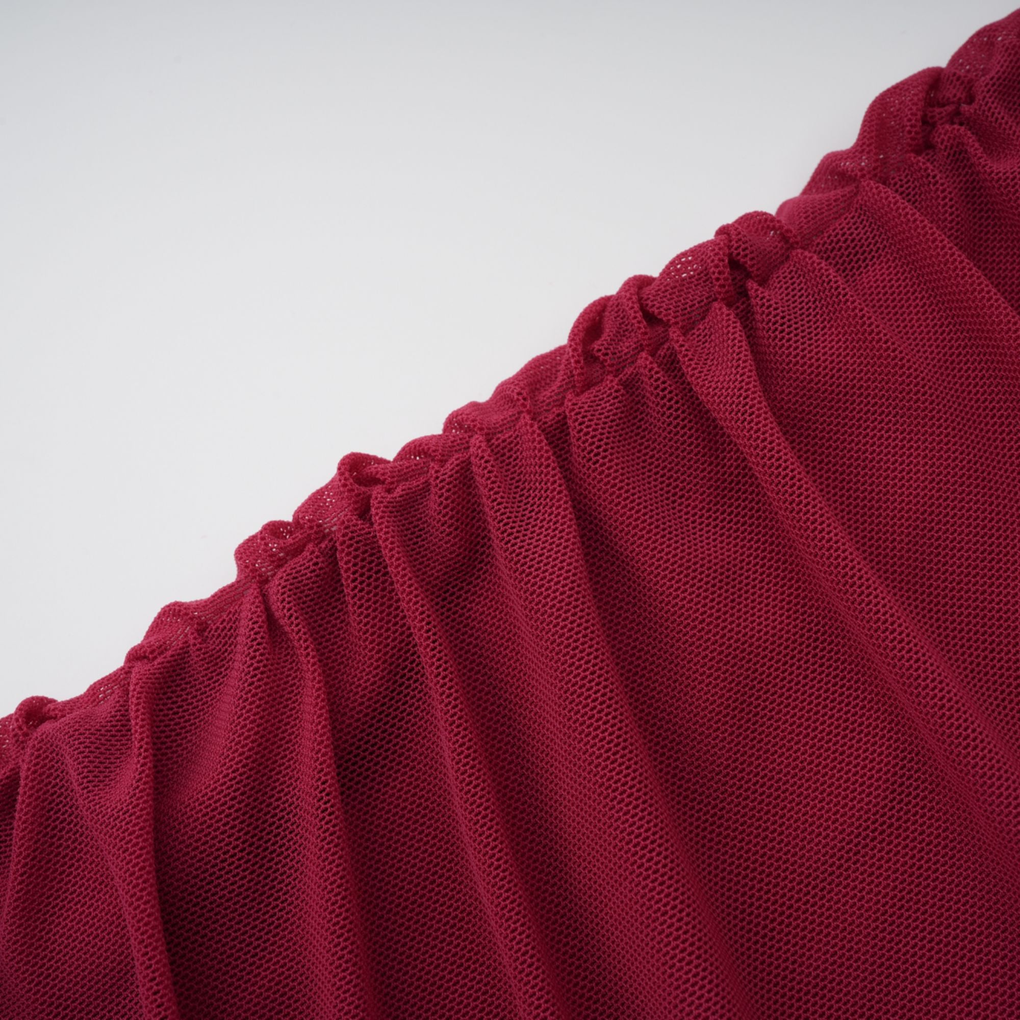 Burgundy ruched gown with a draped high neckline and sheer skirt