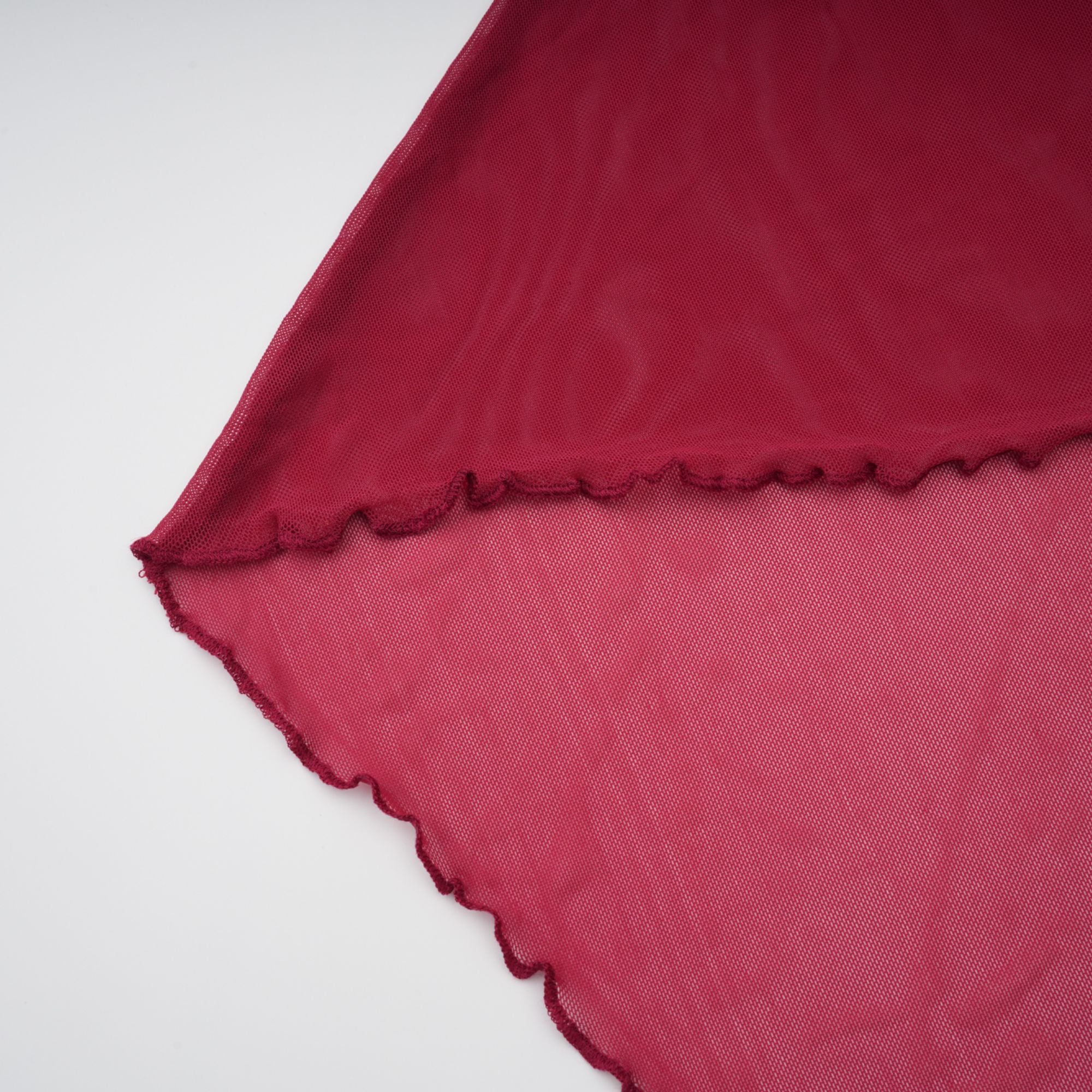 Burgundy ruched gown with a draped high neckline and sheer skirt