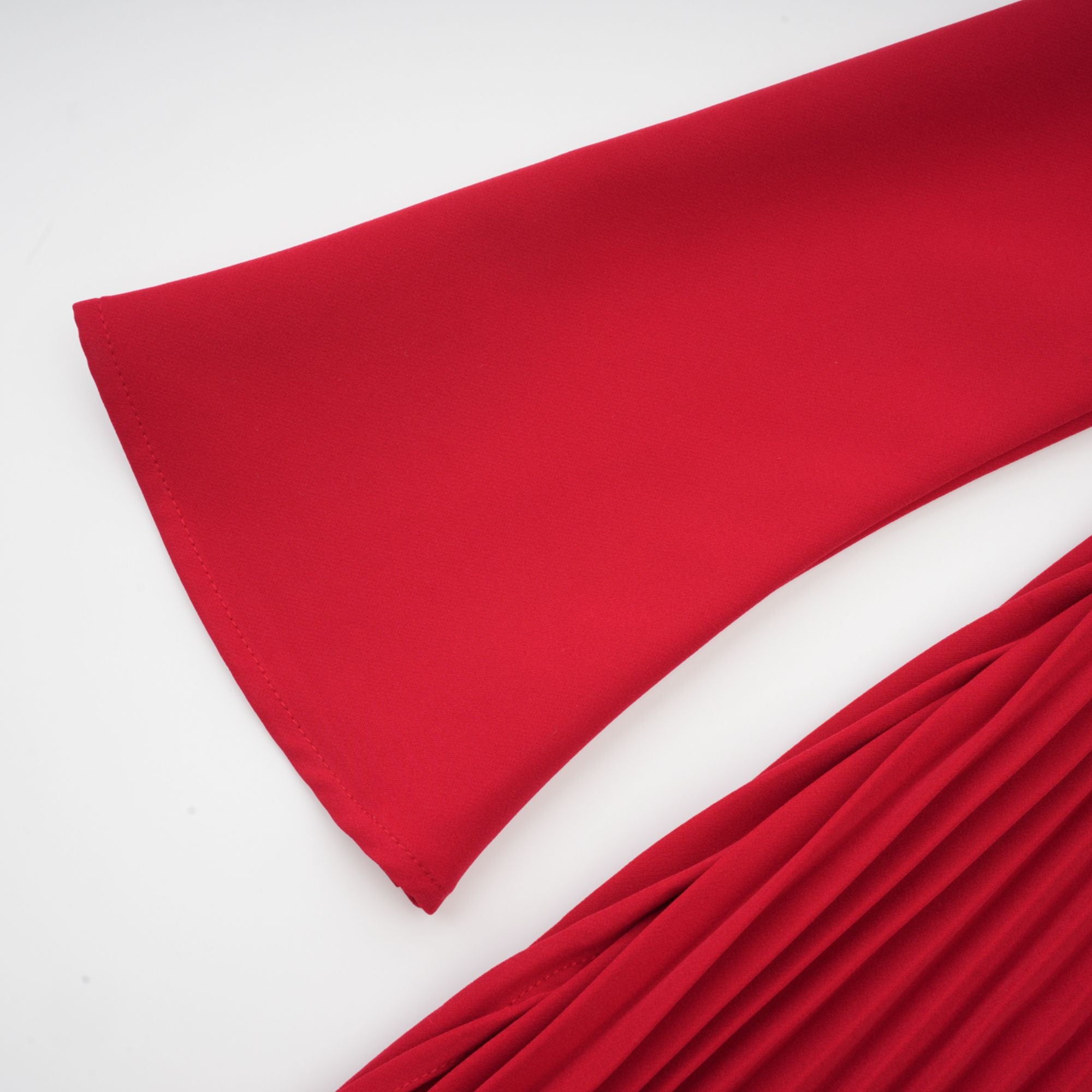 Red off-the-shoulder long-sleeve dress with a pleated skirt panel