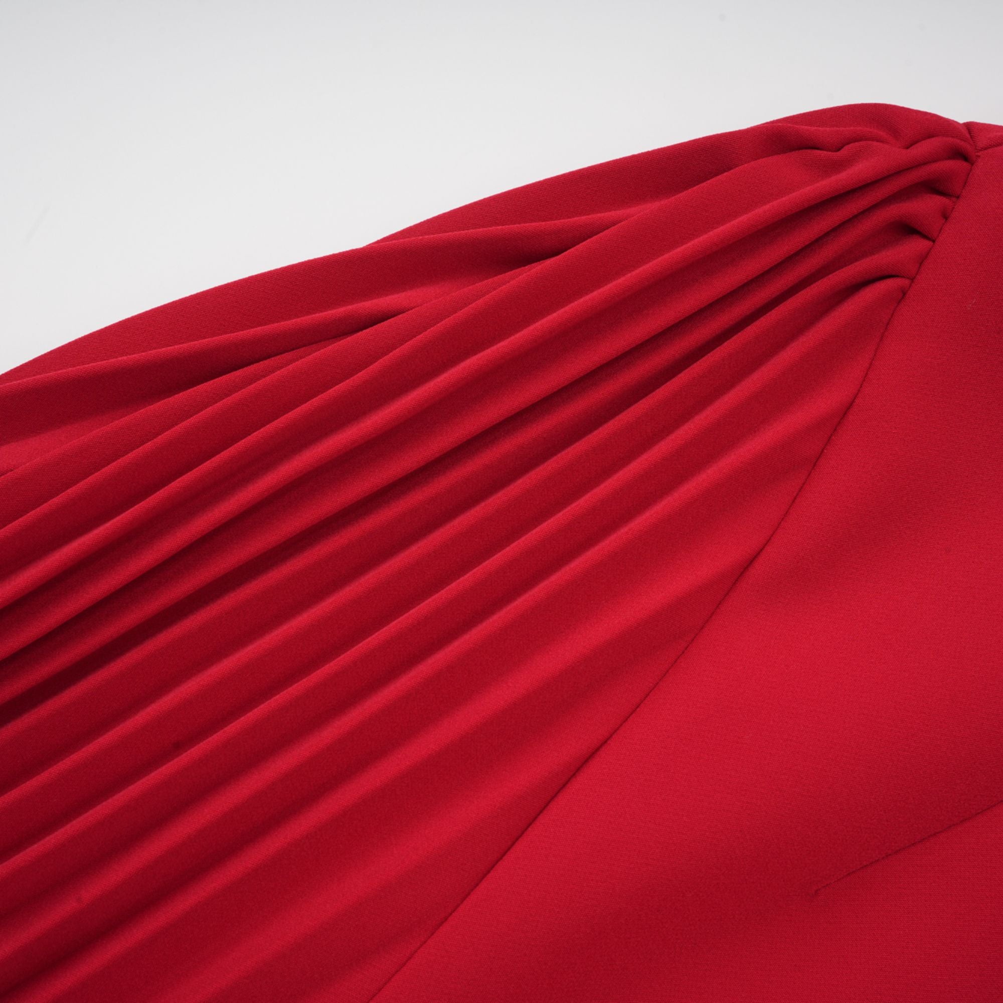 Red off-the-shoulder long-sleeve dress with a pleated skirt panel