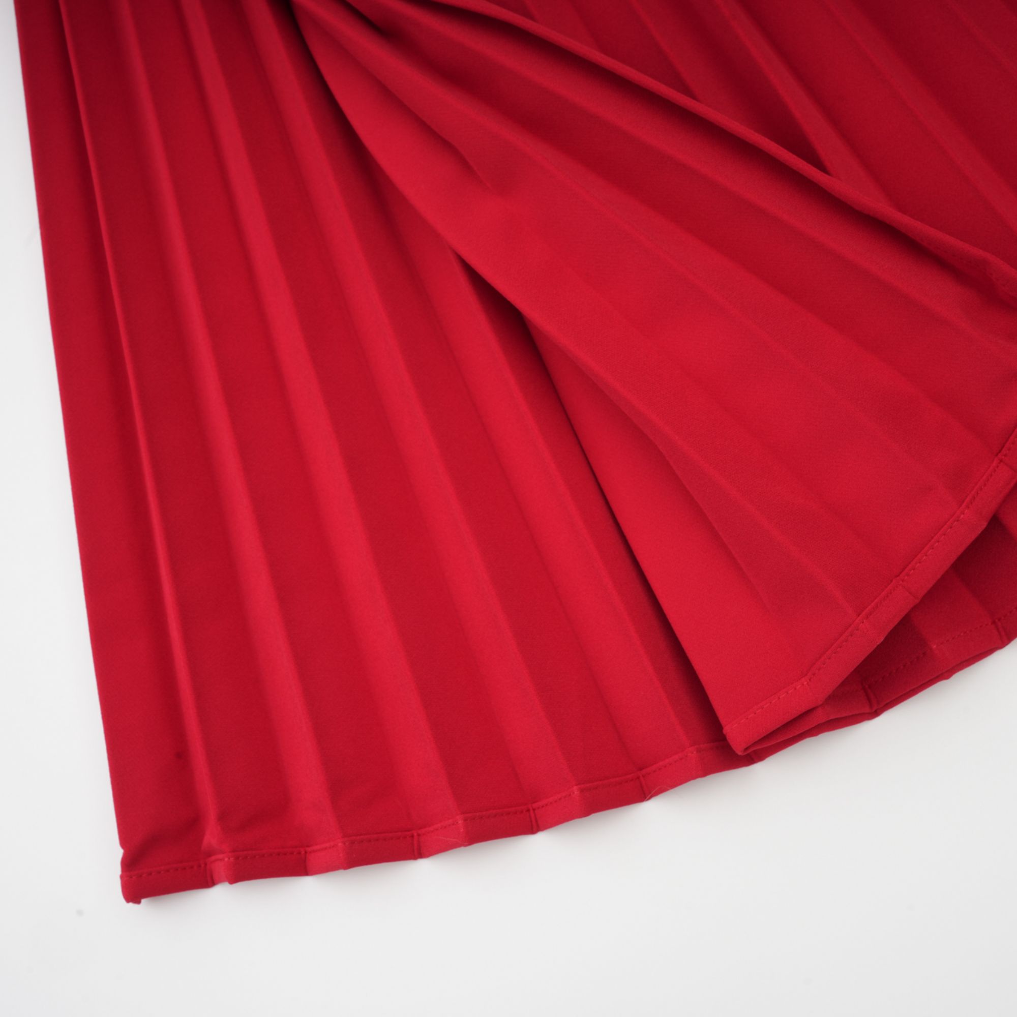Red off-the-shoulder long-sleeve dress with a pleated skirt panel