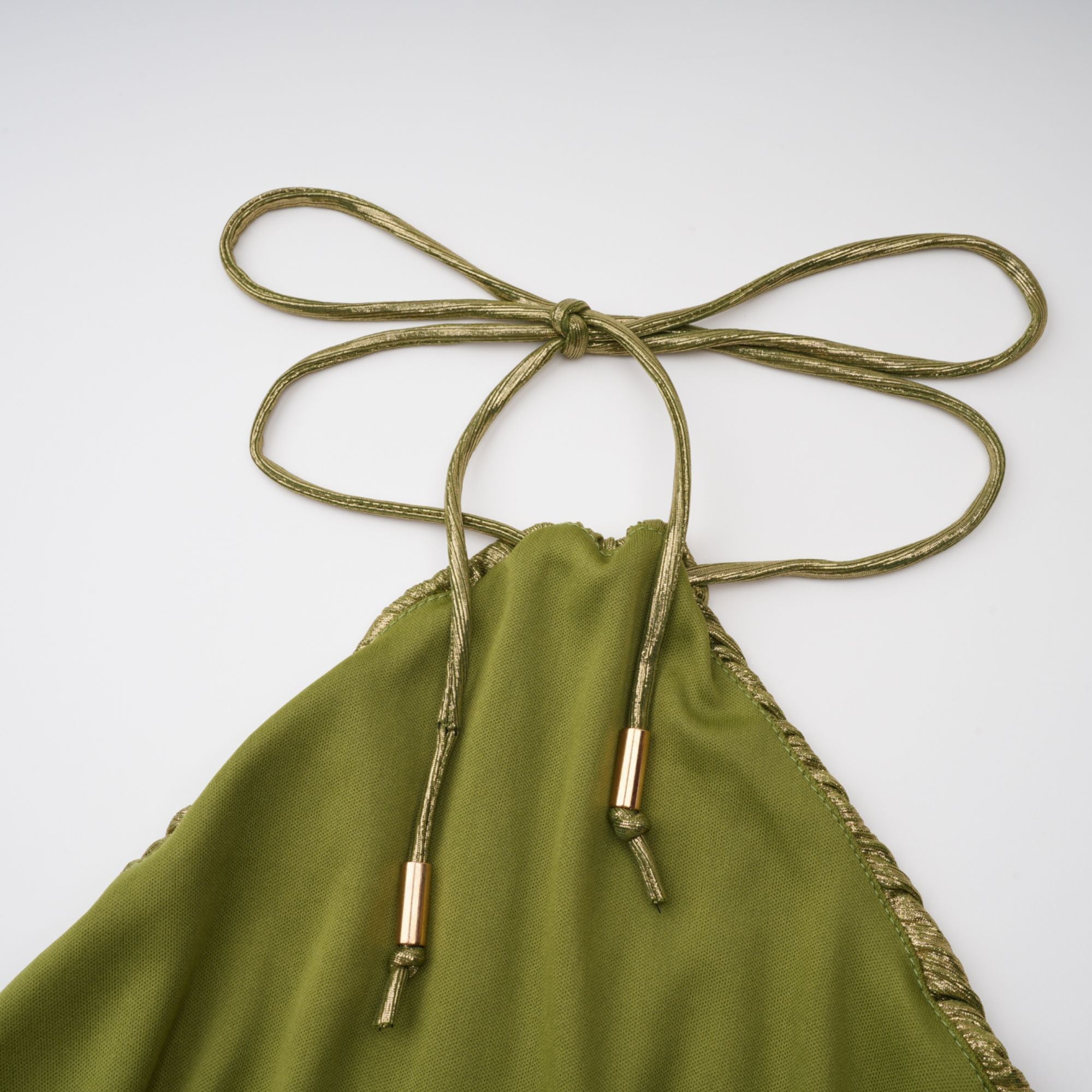 Olive green metallic halter gown with a pleated skirt and high slit