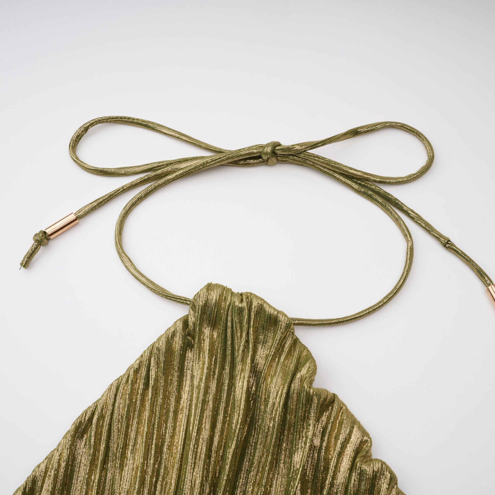 Olive green metallic halter gown with a pleated skirt and high slit