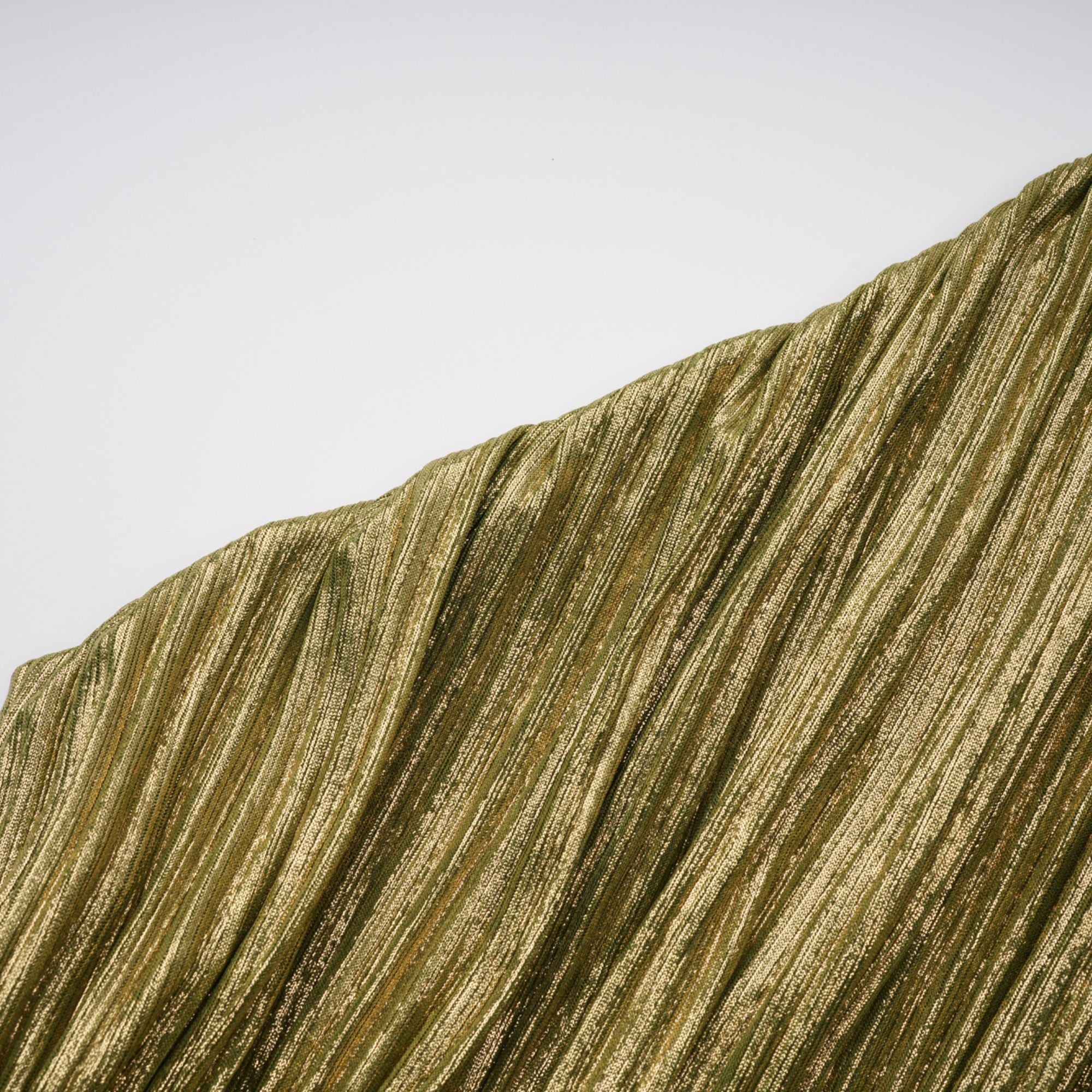 Olive green metallic halter gown with a pleated skirt and high slit