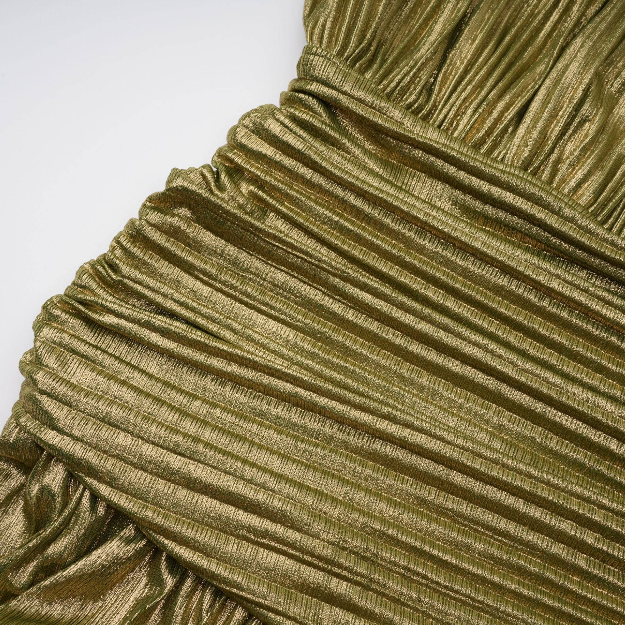 Olive green metallic halter gown with a pleated skirt and high slit