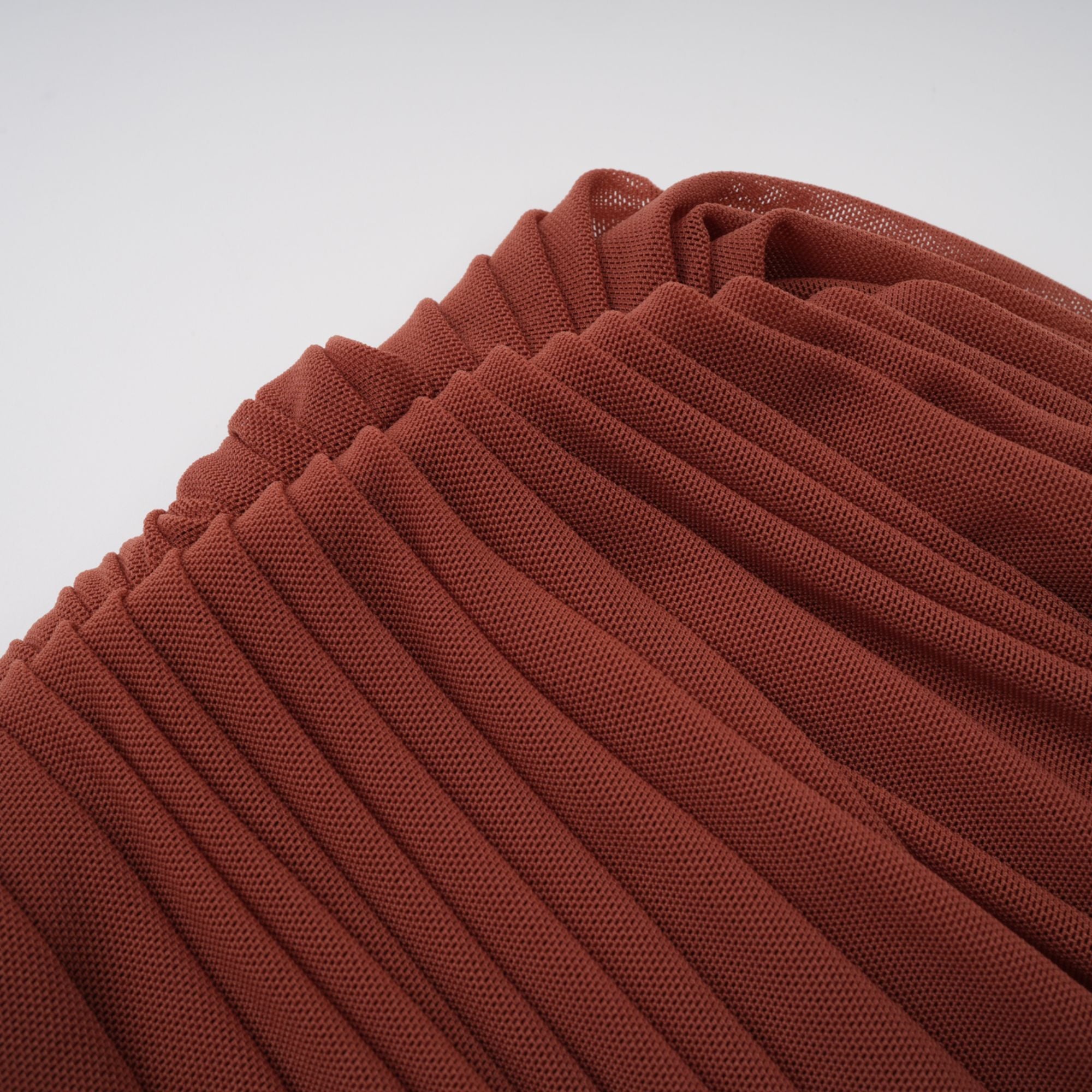 Rust-colored long-sleeve maxi dress with a draped cowl neckline and pleated bodice