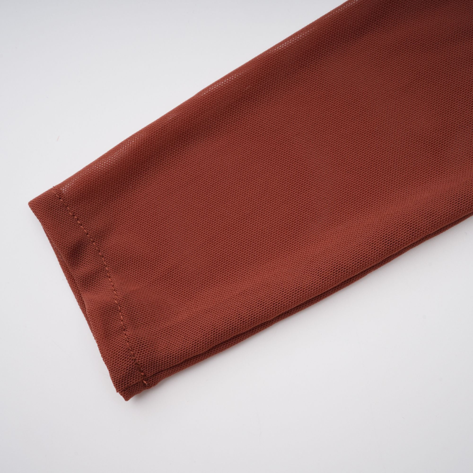 Rust-colored long-sleeve maxi dress with a draped cowl neckline and pleated bodice