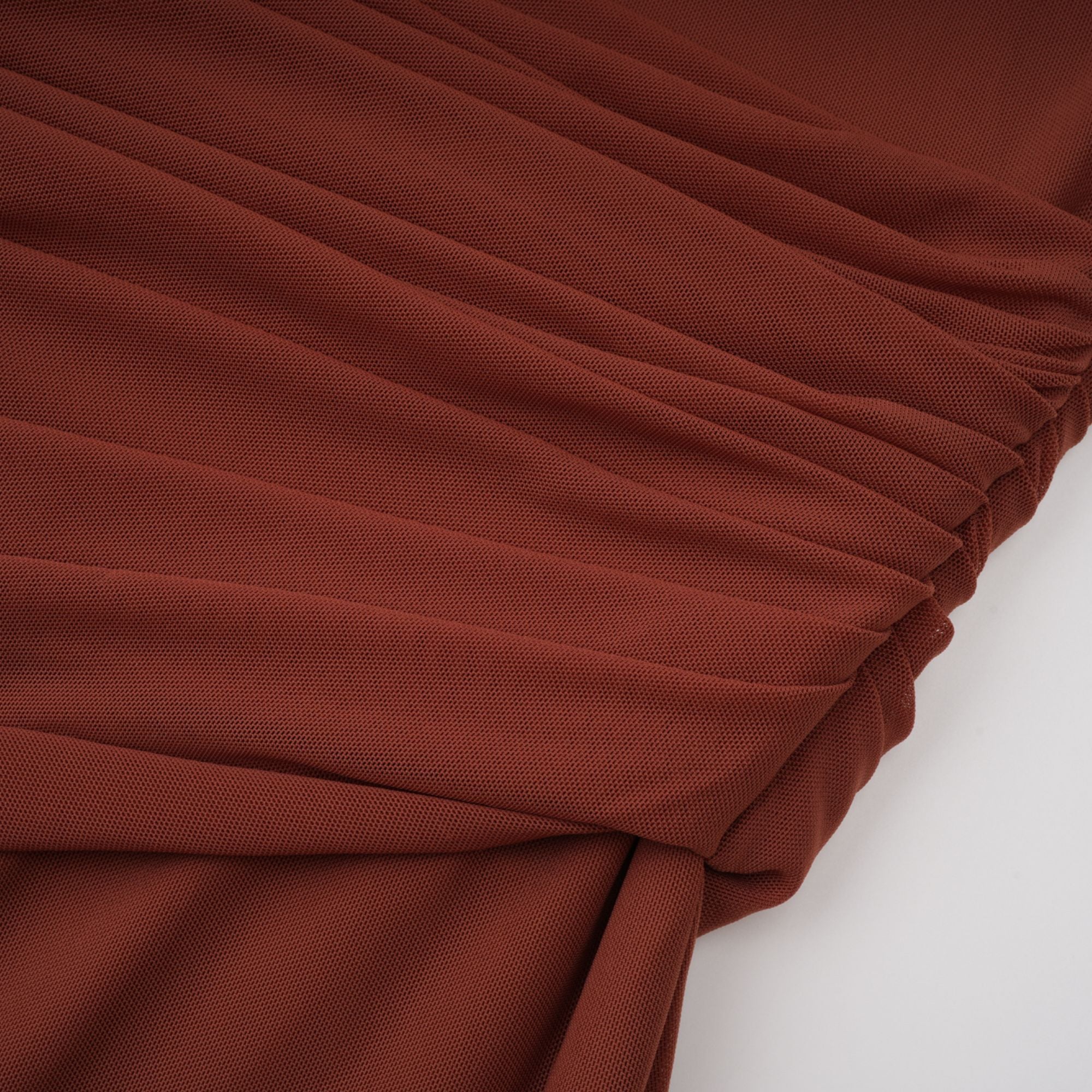 Rust-colored long-sleeve maxi dress with a draped cowl neckline and pleated bodice