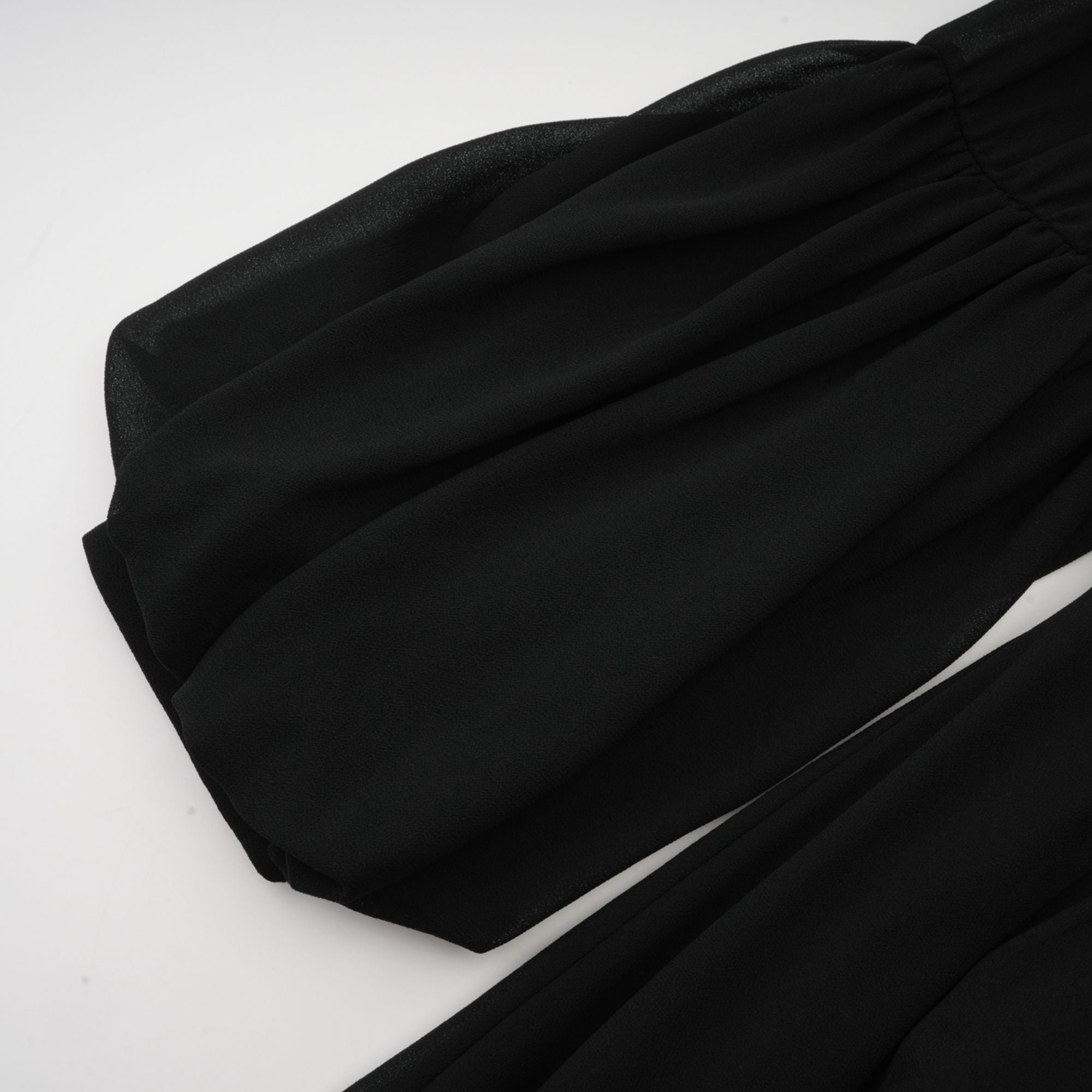 Black pleated midi dress with gold button details