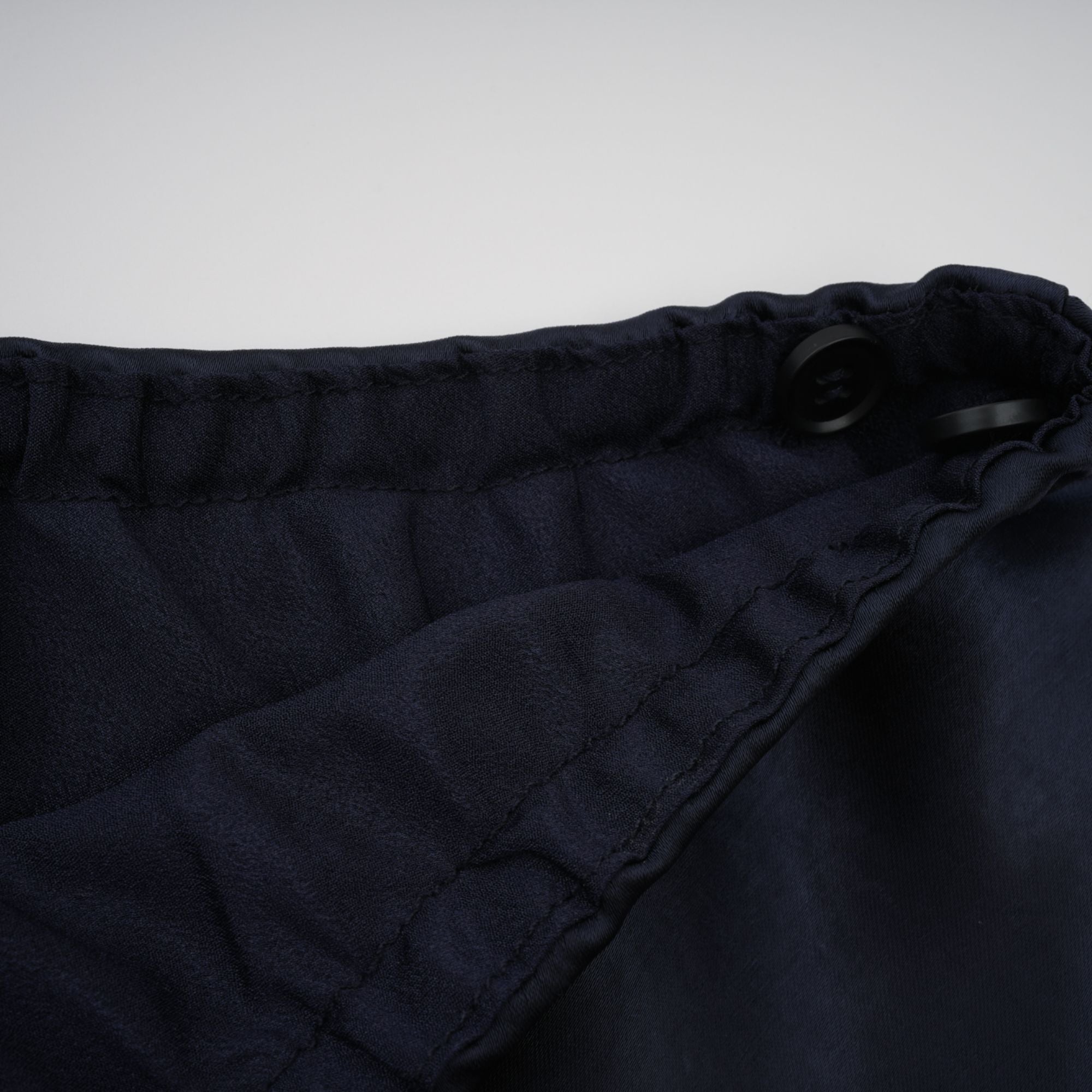 Navy blue short-sleeve maxi dress with a peplum jacket bodice and satin skirt