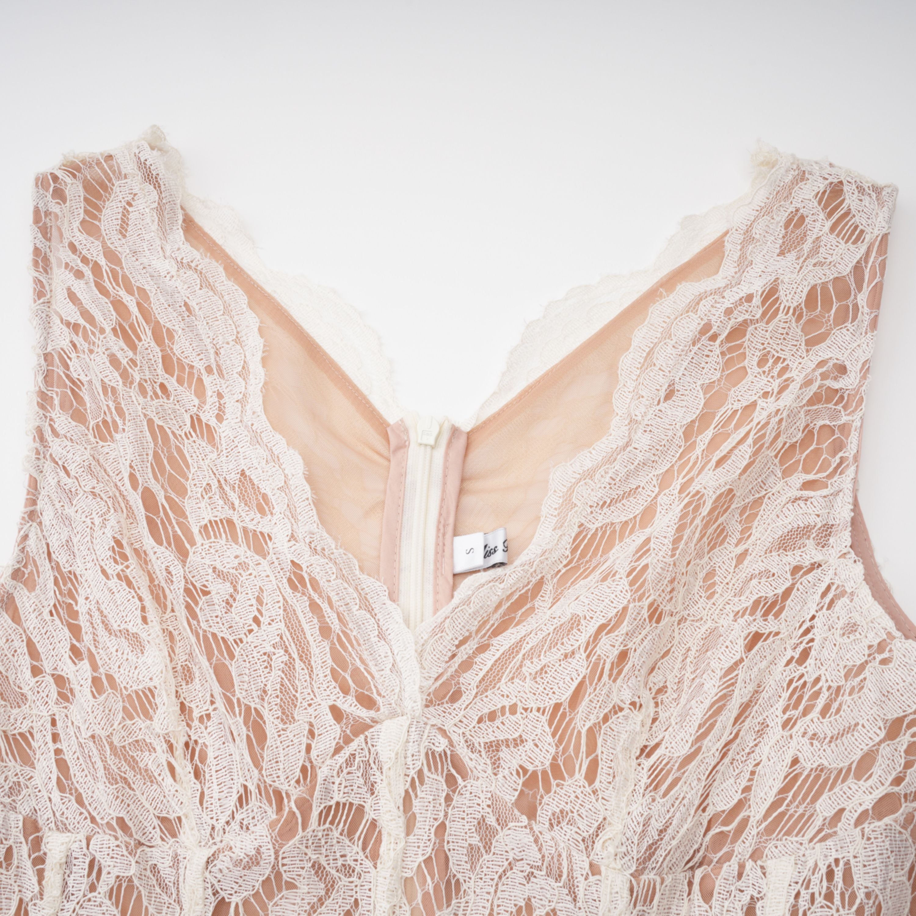 White lace midi dress with a keyhole neckline and a flared skirt over a nude lining