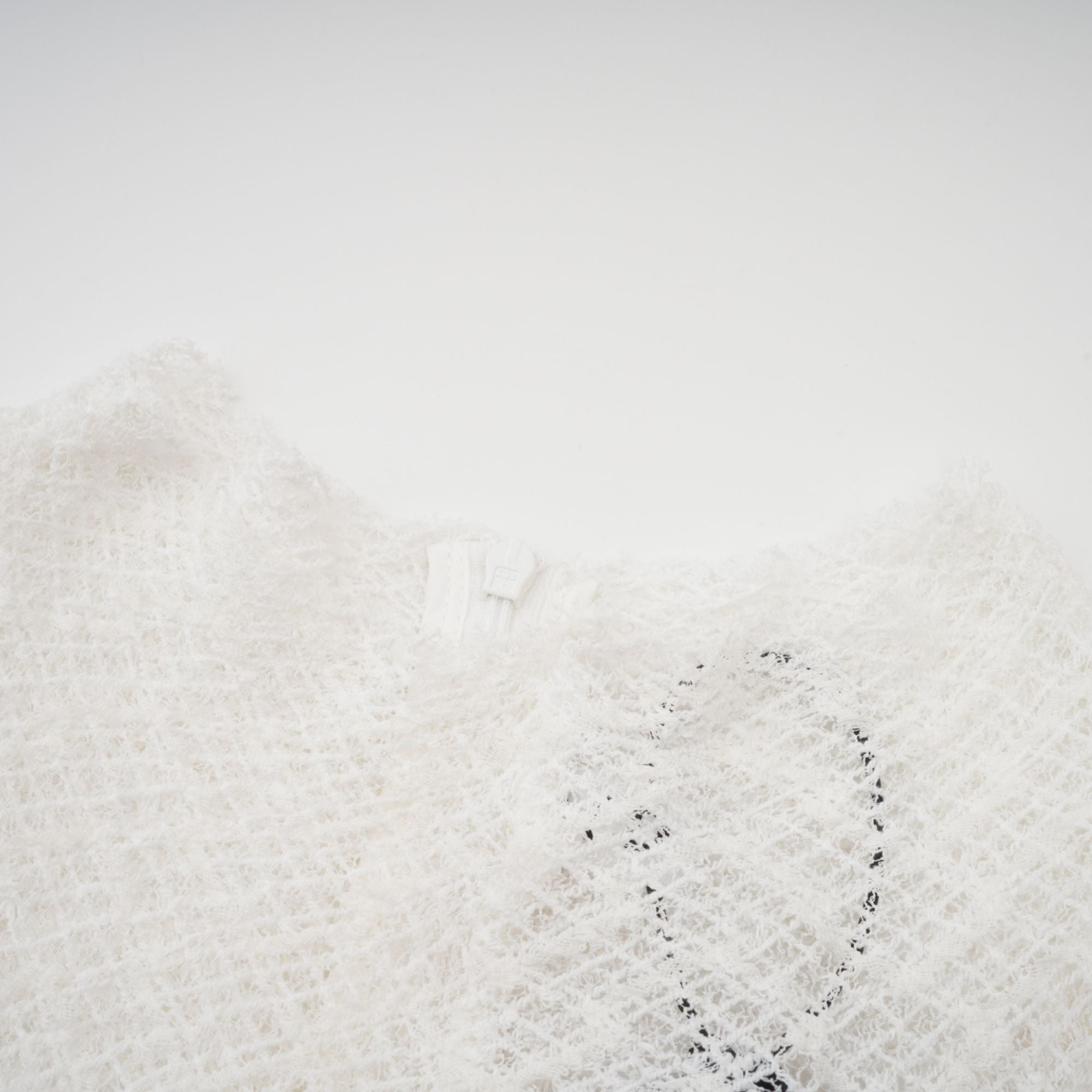 White long-sleeve textured knit gown with a high neck