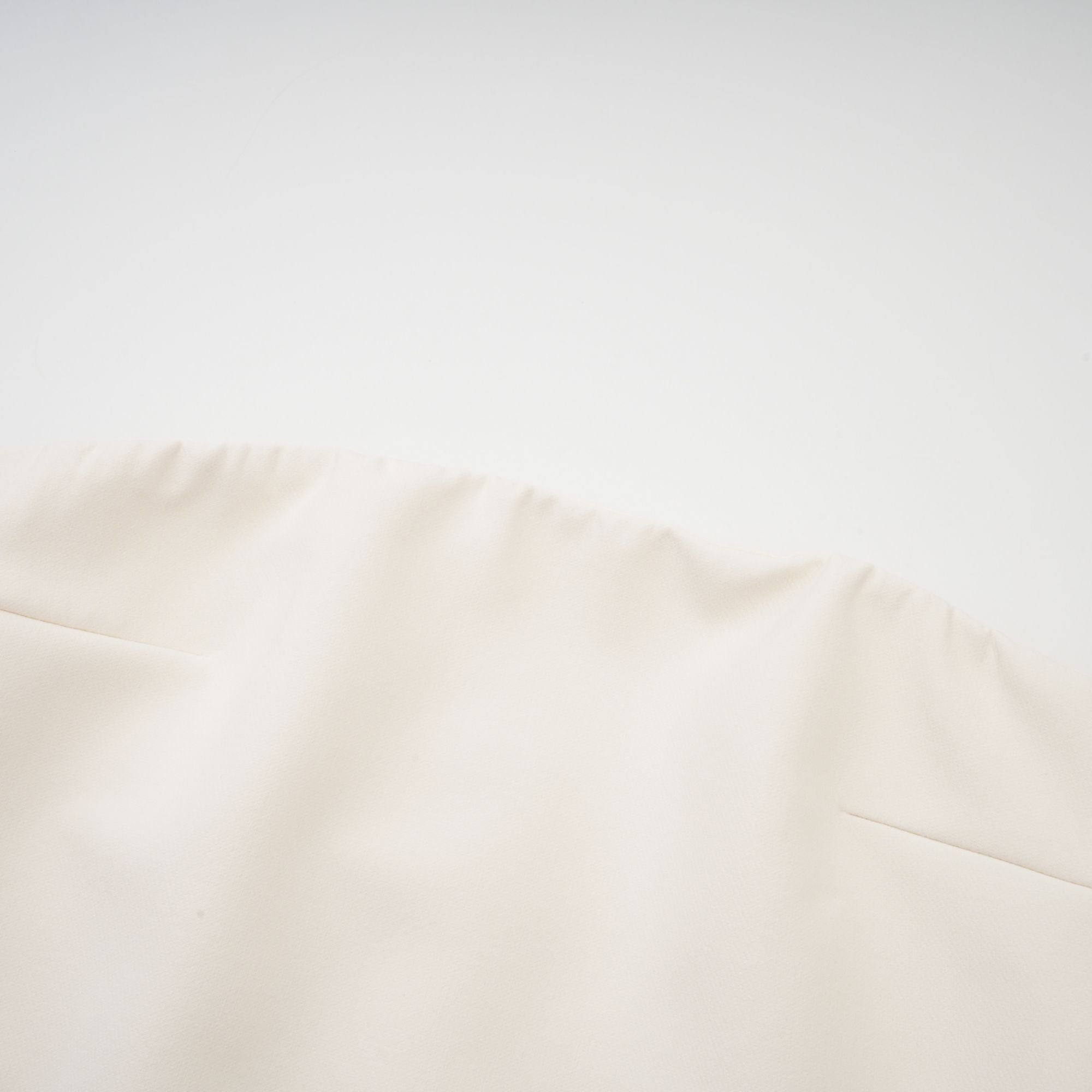 Cream strapless mini dress with a draped cape