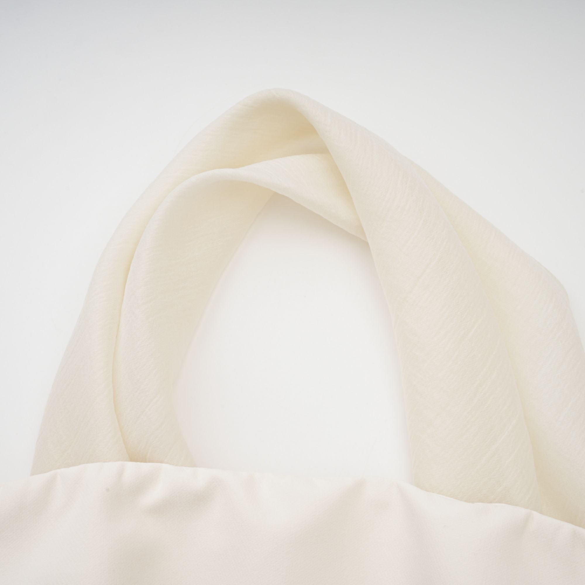 Cream strapless mini dress with a draped cape