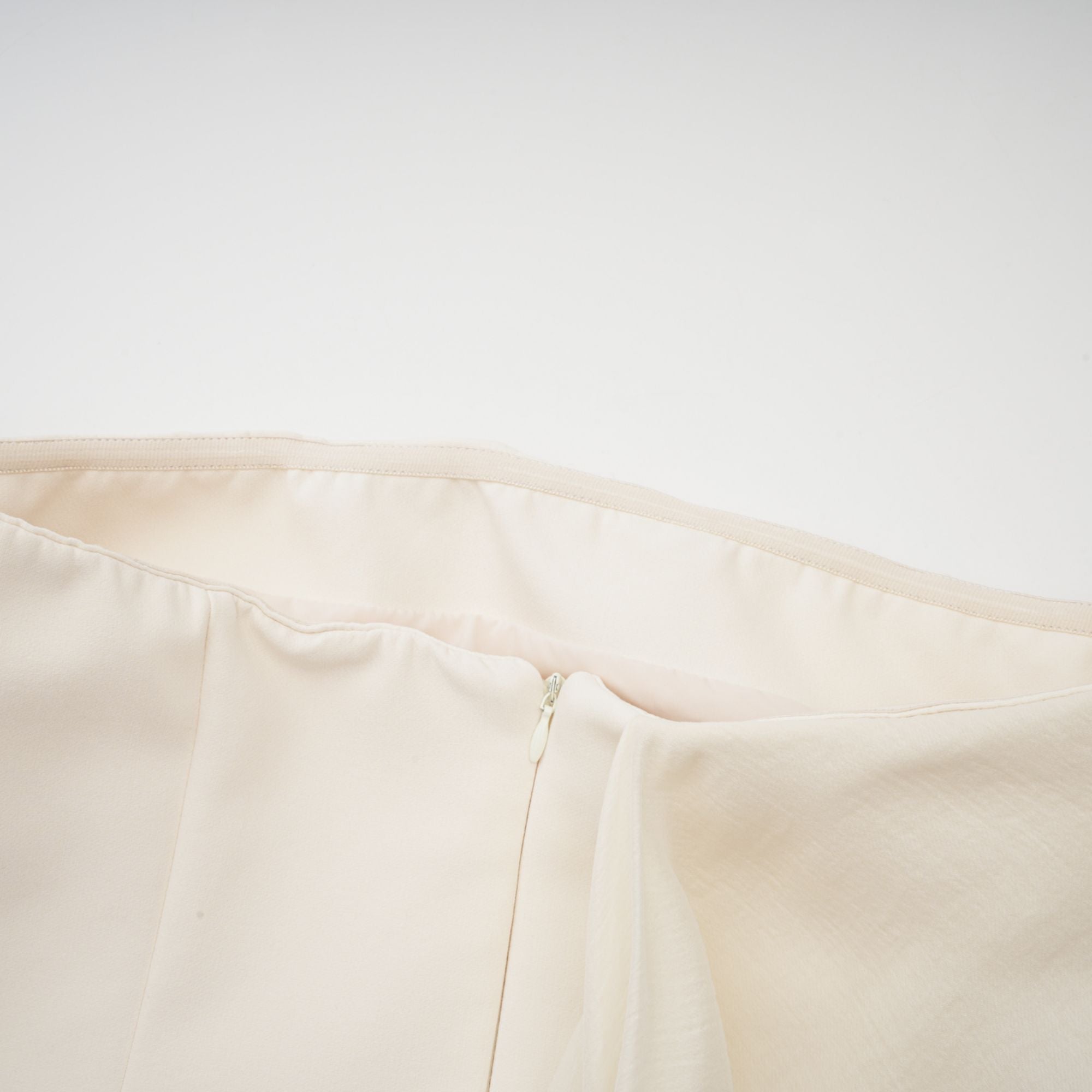 Cream strapless mini dress with a draped cape