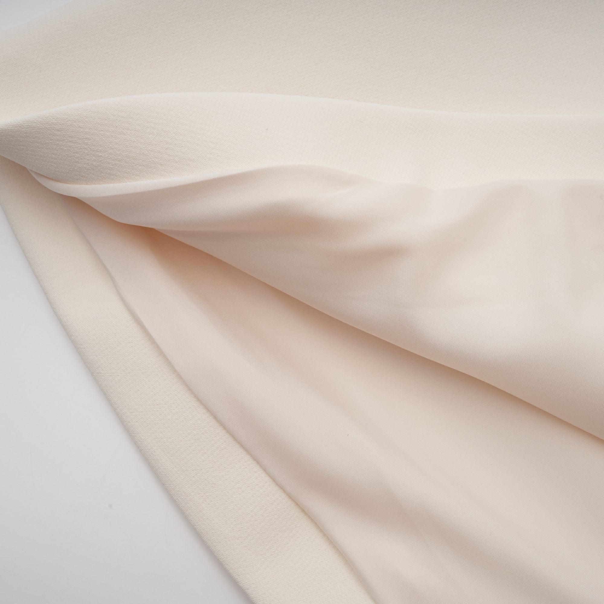 Cream strapless mini dress with a draped cape