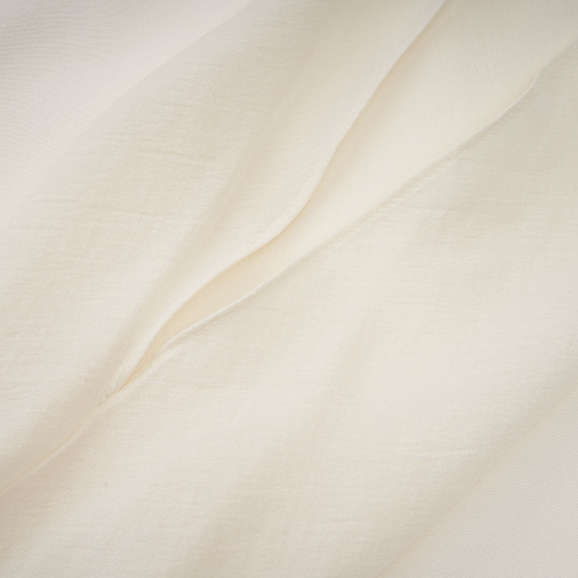 Cream strapless mini dress with a draped cape