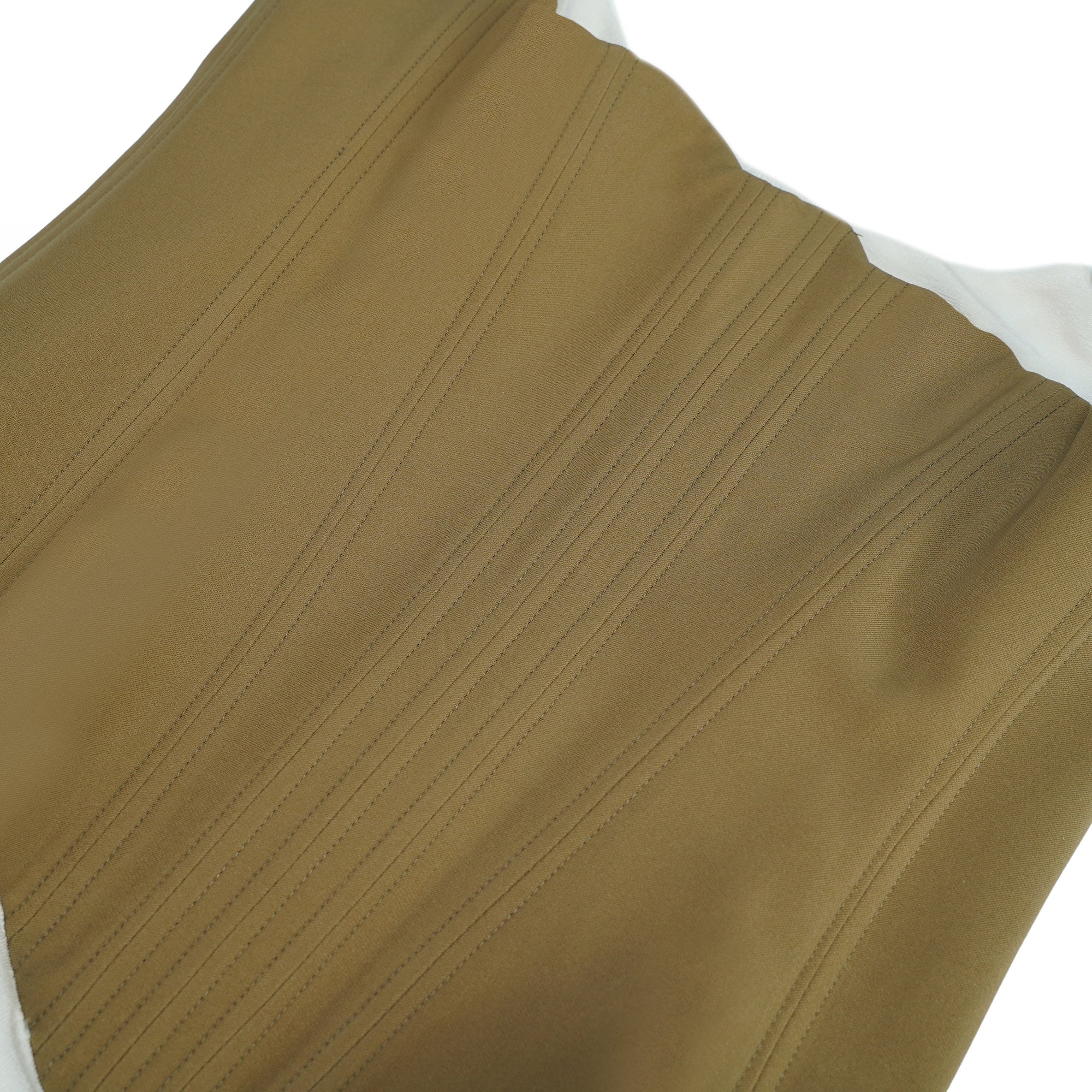 White camisole mini dress featuring a structured tan corset bodice and a draped ruched skirt with drawstring details