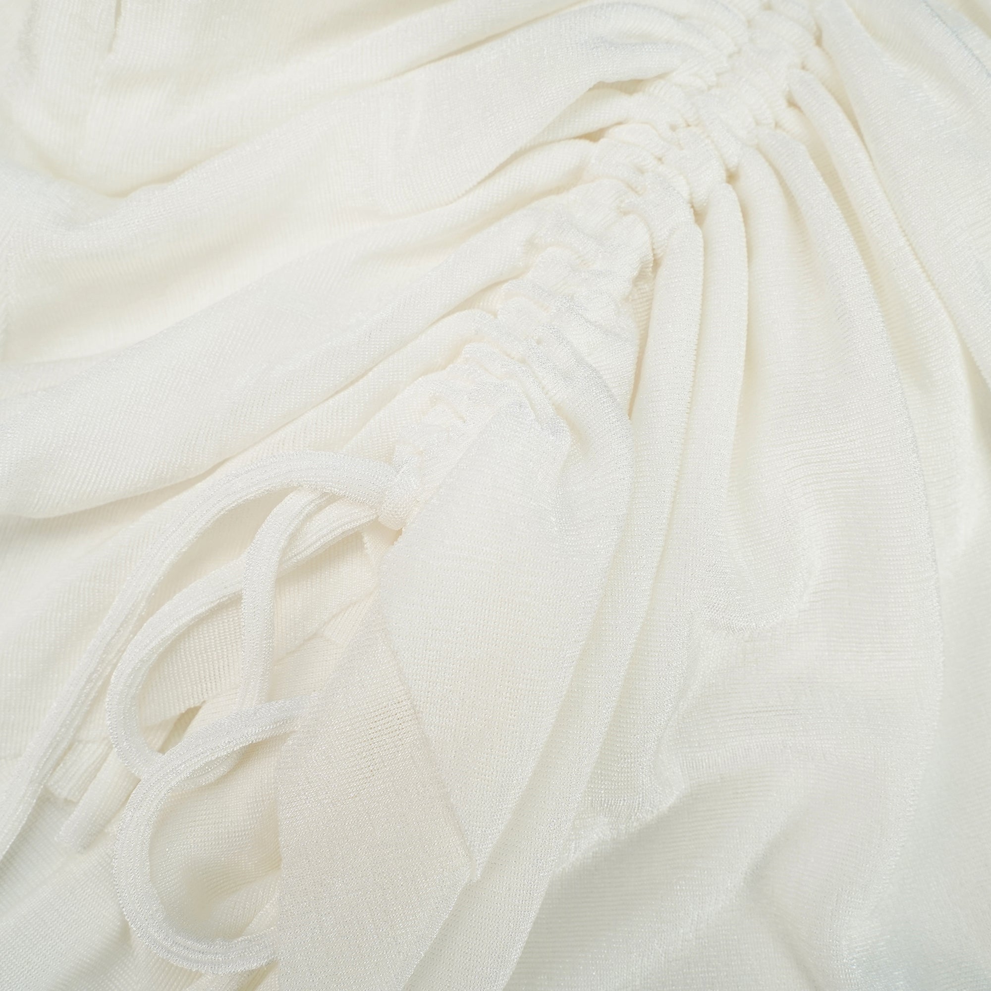 White camisole mini dress featuring a structured tan corset bodice and a draped ruched skirt with drawstring details