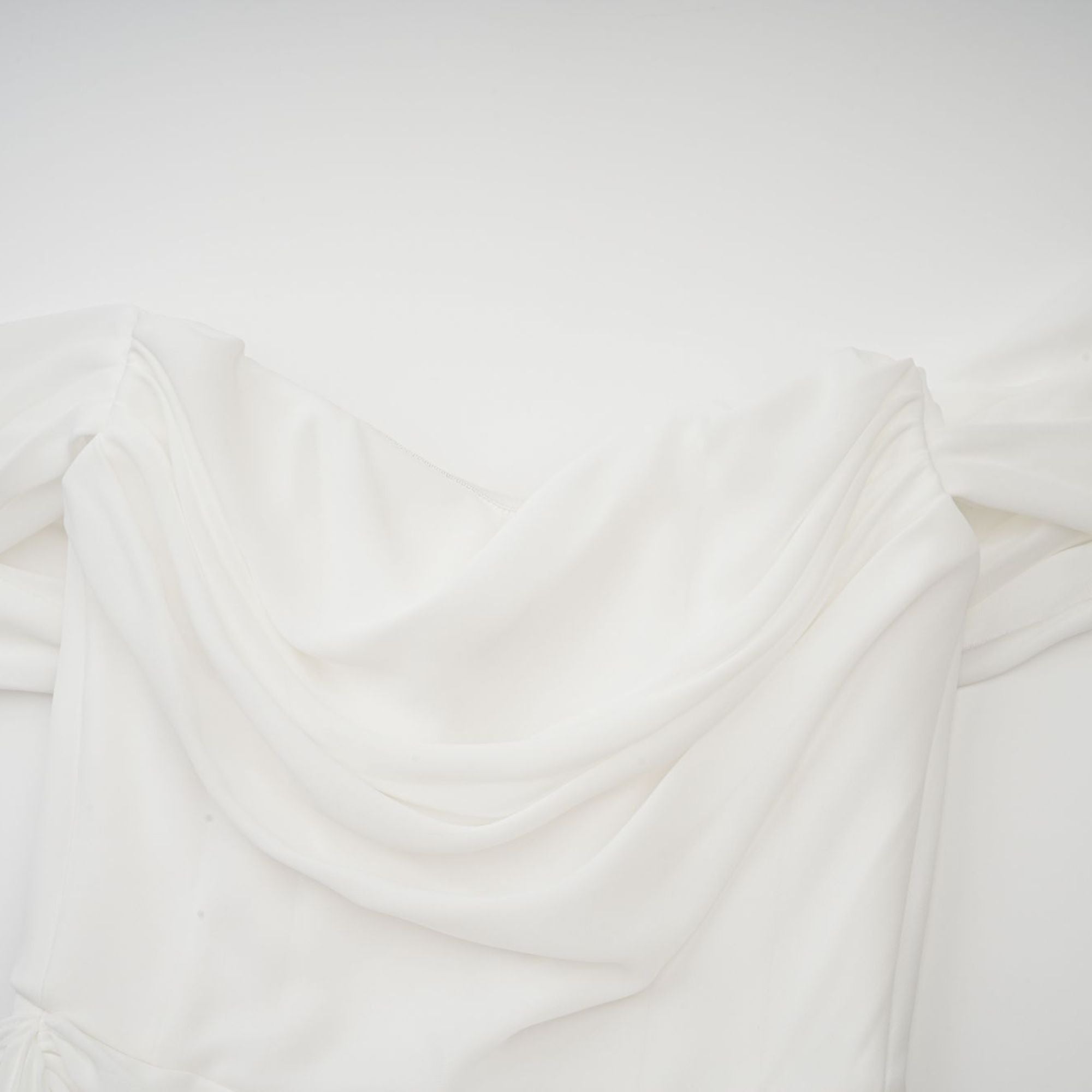 White off-the-shoulder draped mini dress with side panels
