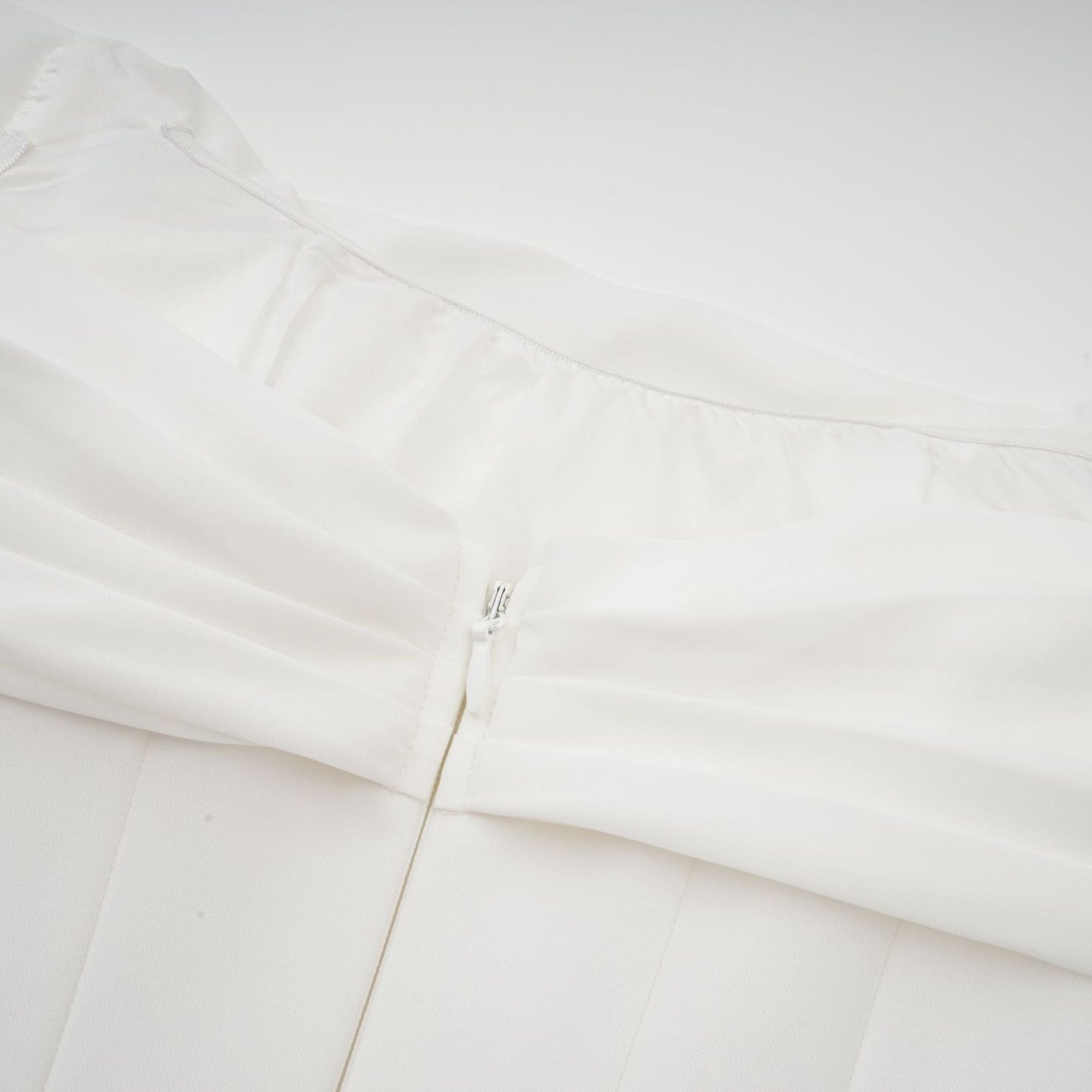 White off-the-shoulder draped mini dress with side panels