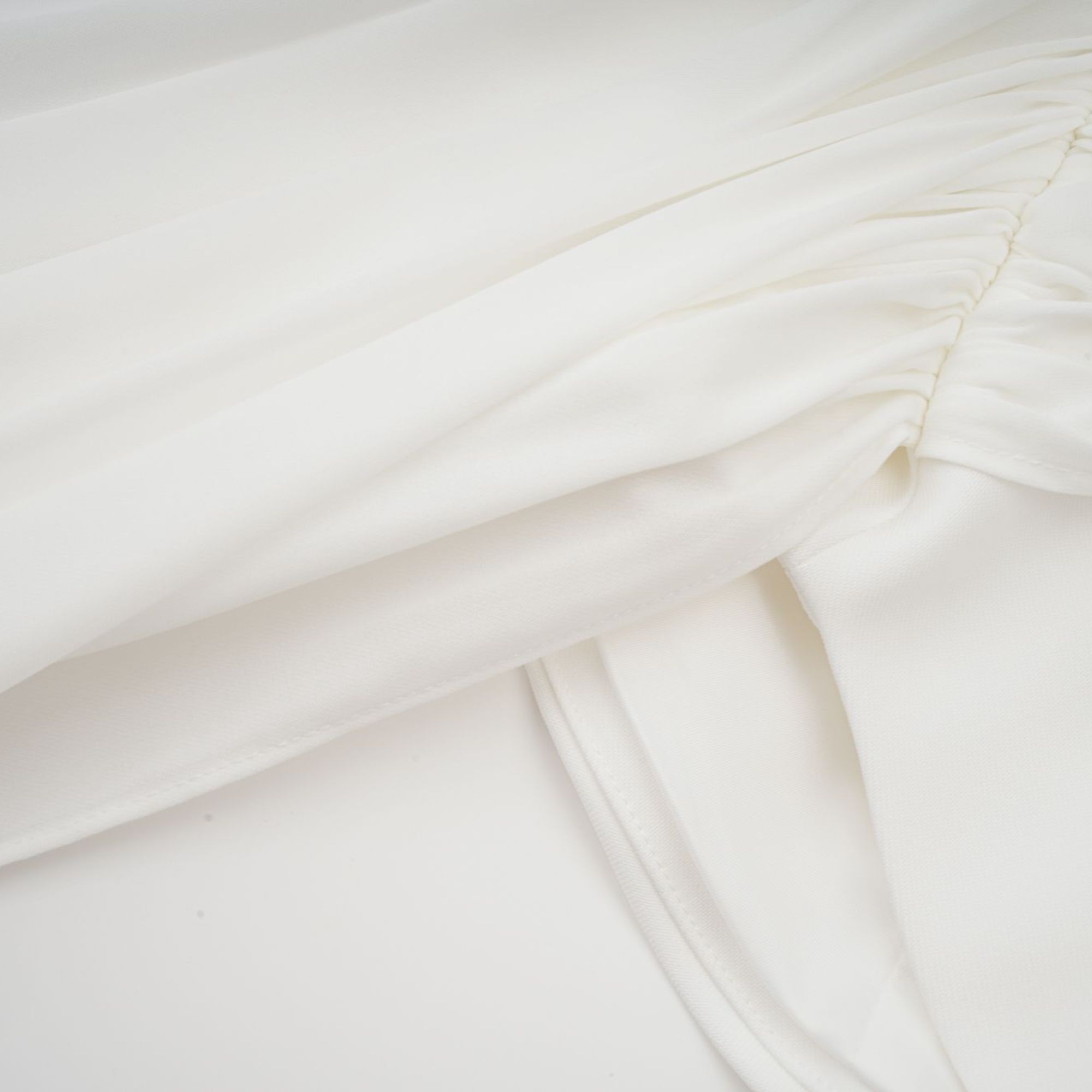 White off-the-shoulder draped mini dress with side panels