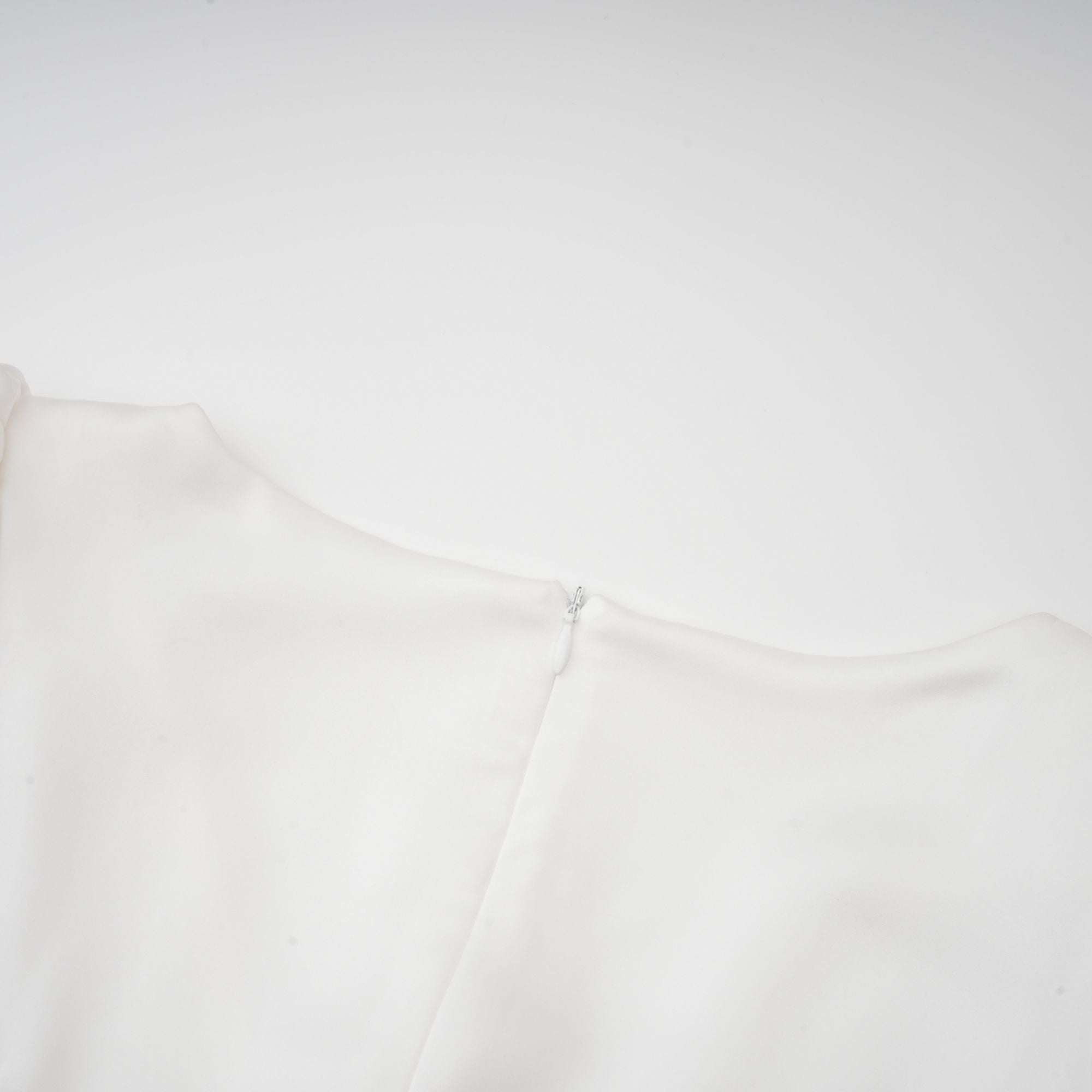 White satin V-neck midi dress with black bow shoulder straps