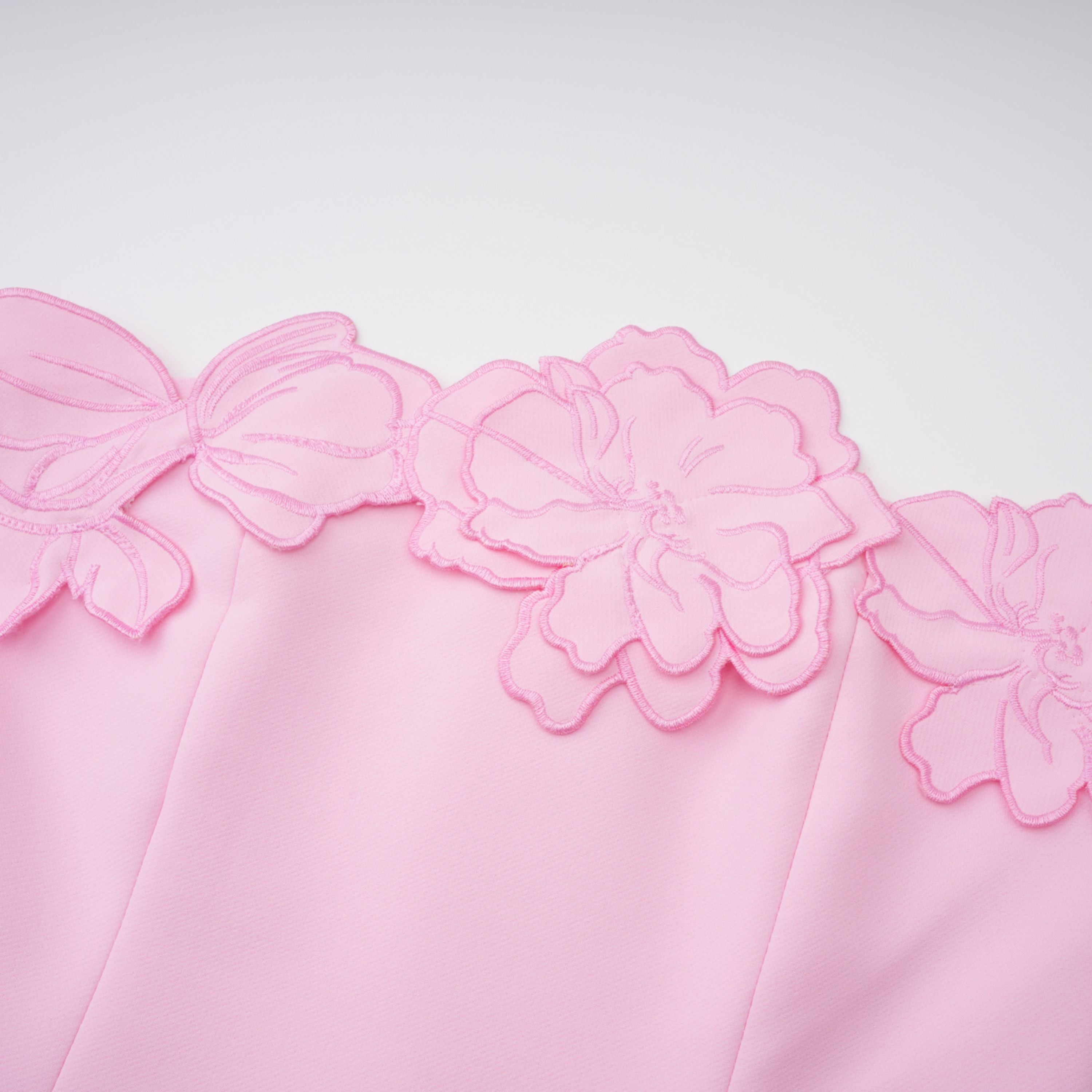 Pink strapless midi dress with a cutout floral hem