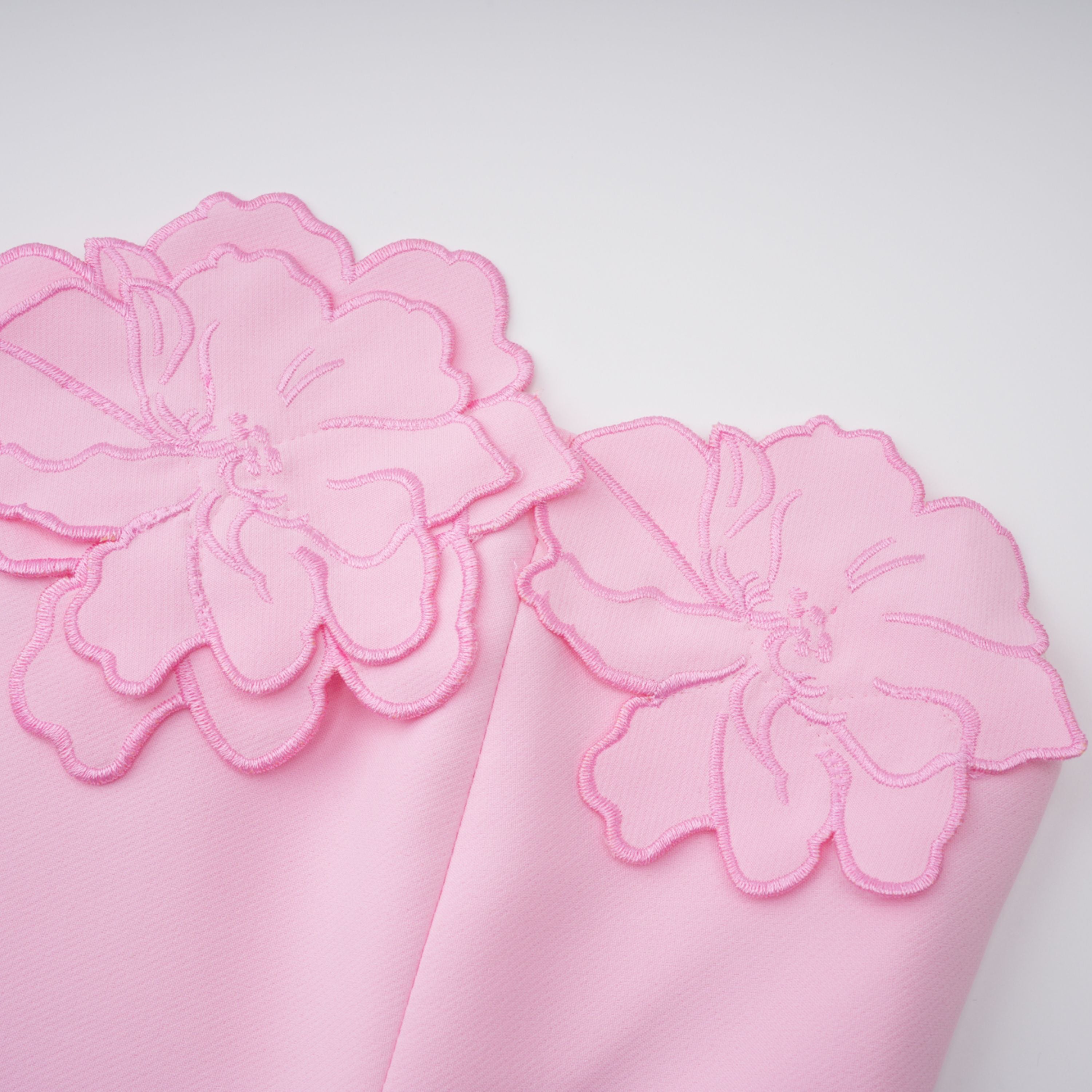 Pink strapless midi dress with a cutout floral hem