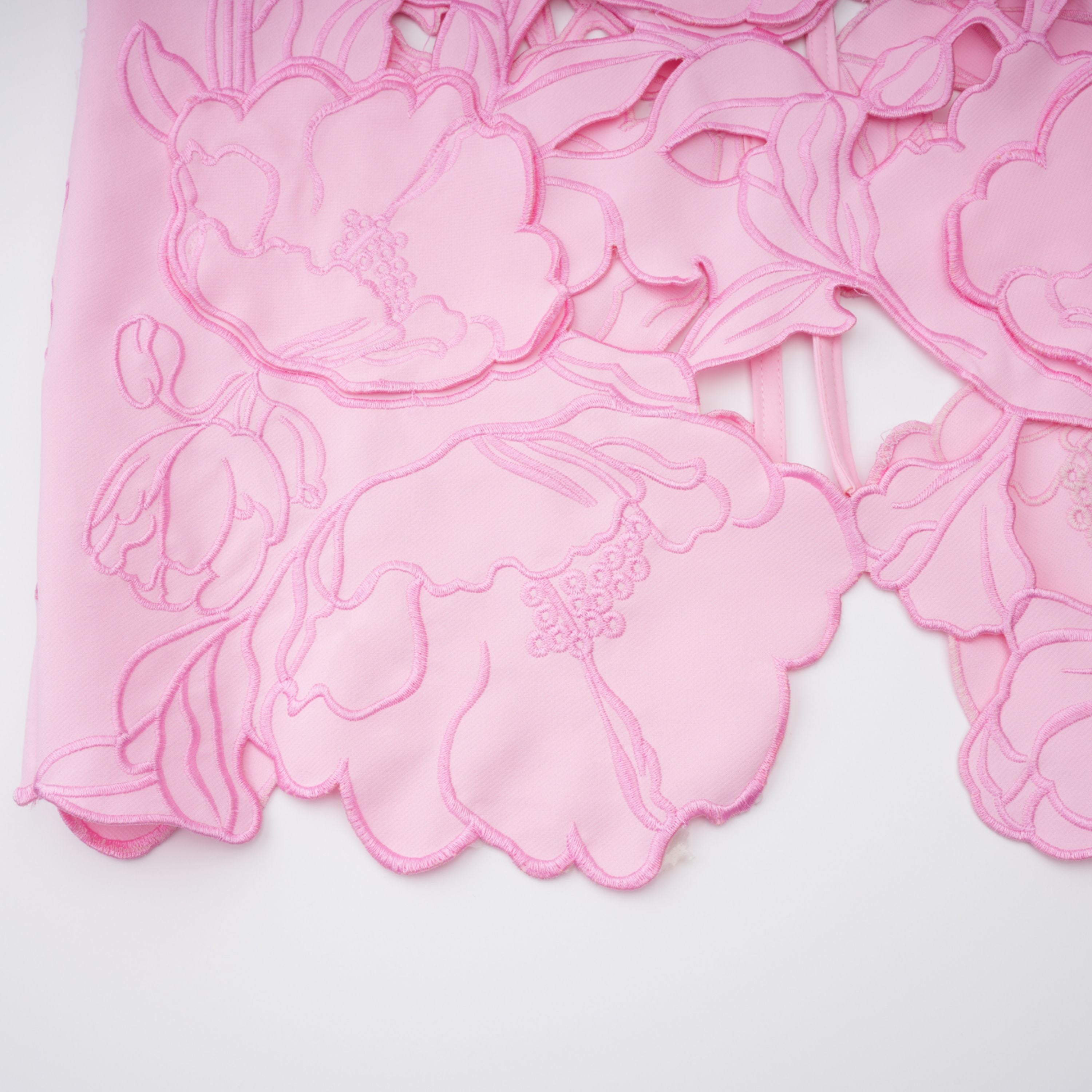 Pink strapless midi dress with a cutout floral hem
